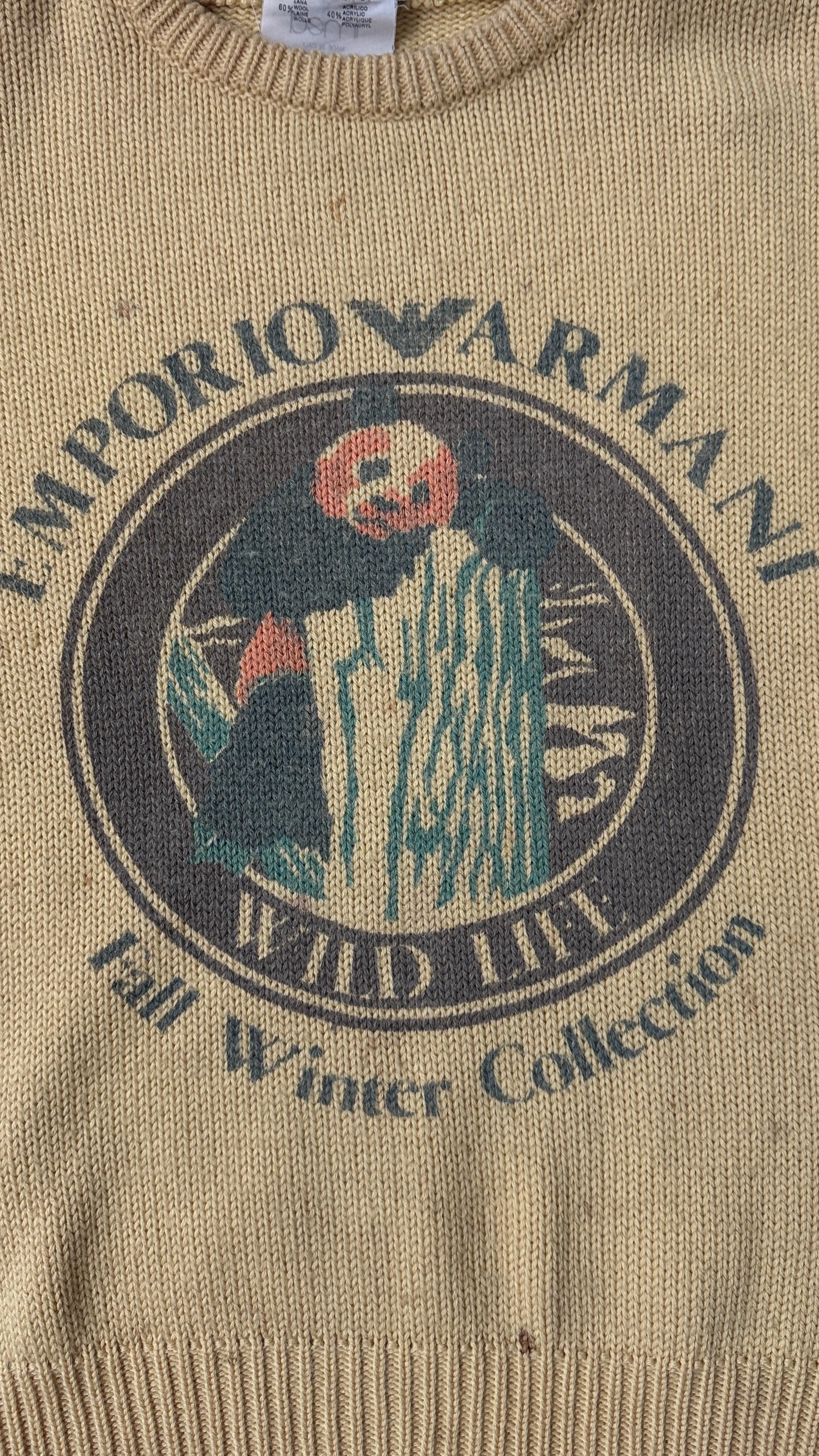 Rare and iconic vintage sweater from Emporio Armani’s Wild Life series, likely part of the Fall/Winter collections from the late 1980s or early 1990s. This collector’s piece features a unique front graphic depicting a stylized panda perched on a