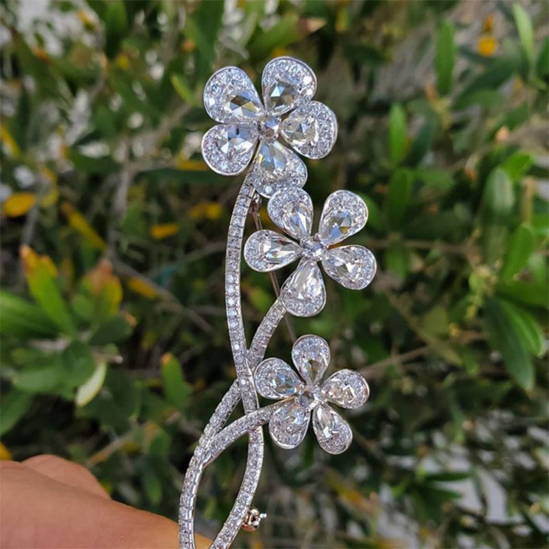 Vintage, En tremblant, 18 karat white gold rose cut diamond flower brooch. This is one of the most beautiful and well made pins. It's made for both women and men. The petals in the flowers are rose cut diamonds that are white in color and eye clean.