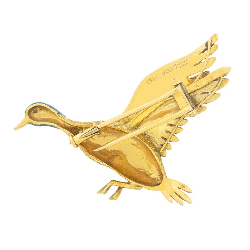 This charming mallard duck brooch was made in the 1970s. The body is made of solid 18 carat gold, and is beautifully and intricately formed- with great detail on the feathers. The head is beautifully enamelled, giving a luminescent glow, similar to