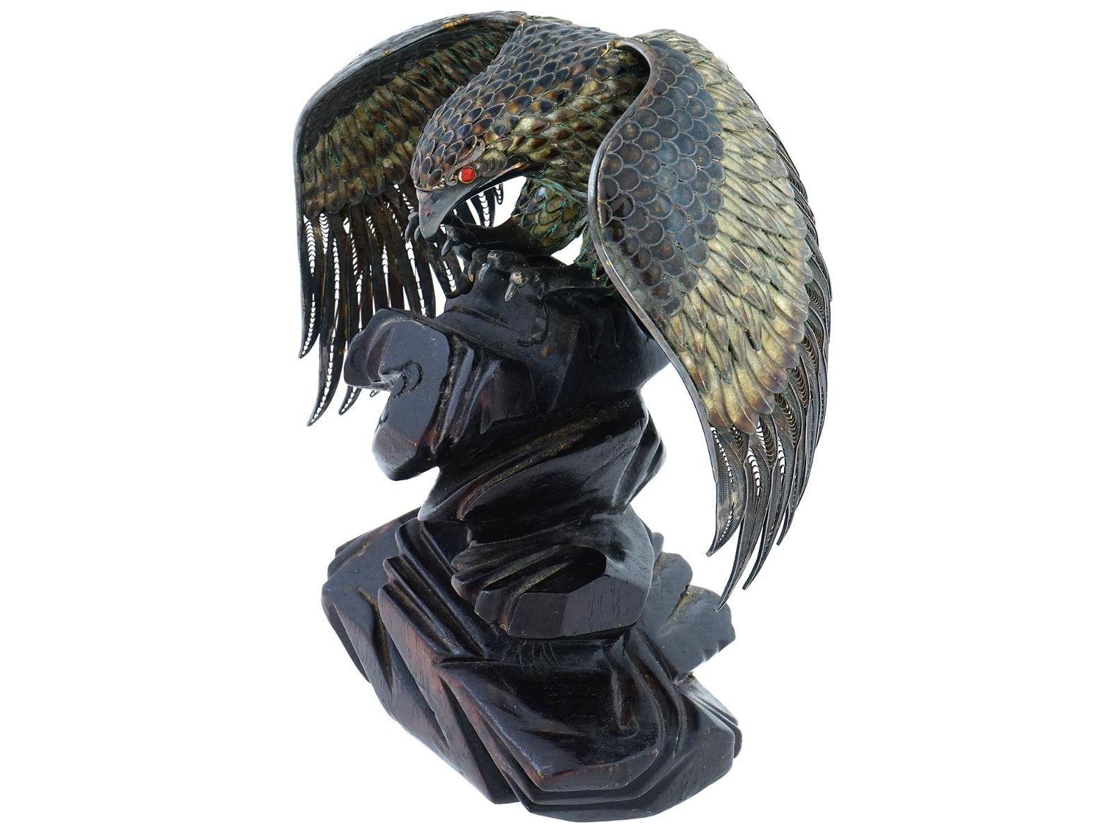 Beautiful vintage figurine of a perched eagle with spread wings finely crafted from silver filigree with enamel feathers, mounted on ebonized wooden rock form base.  With high degree of tarnish but in excellent condition.  7 3/4 inches tall.