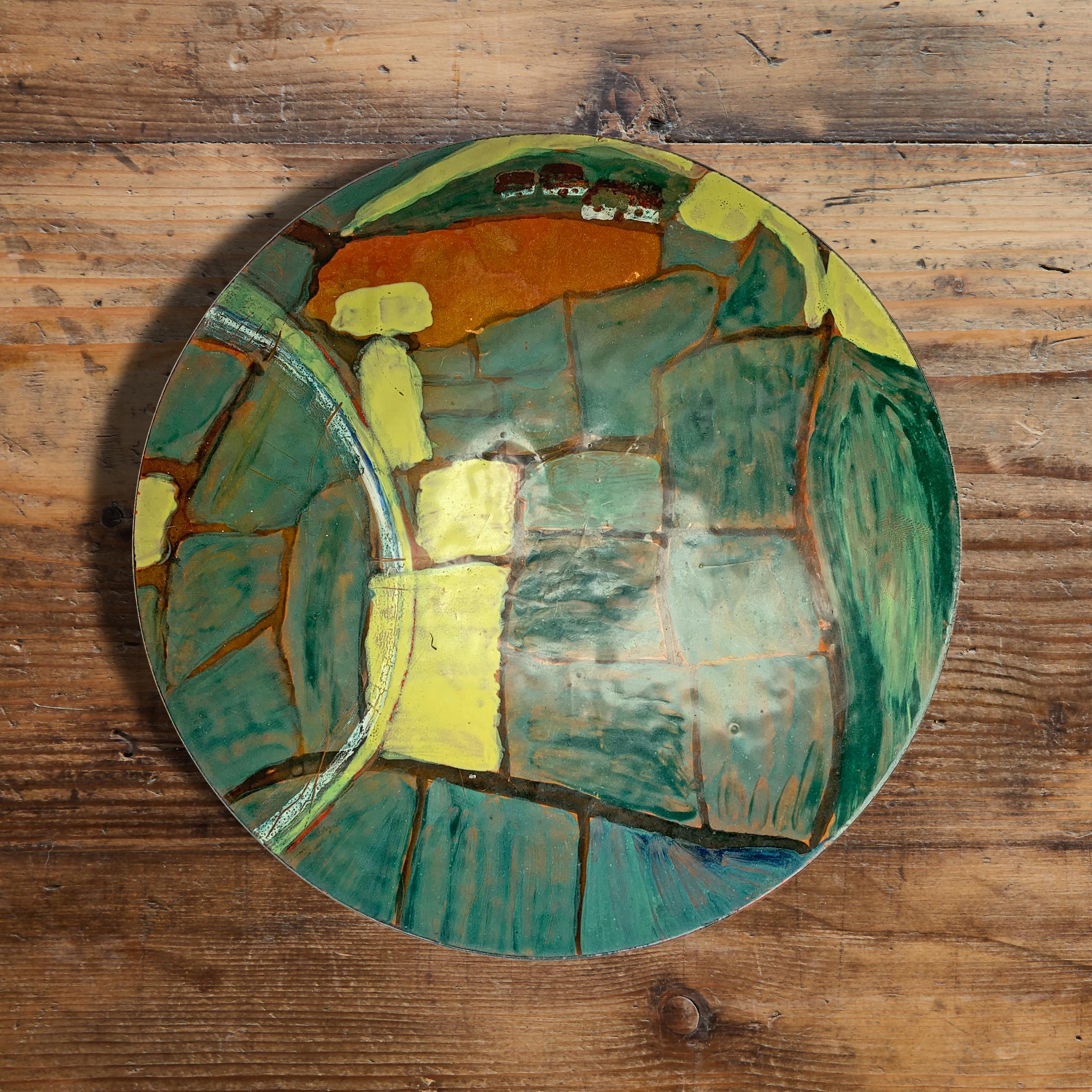 A wonderful vintage enamel on copper bowl with a modernist design depicting an Arial view of a farm with houses and fields, roads and streams. Signed 'Patty Gebhardt' and dated '1981'.