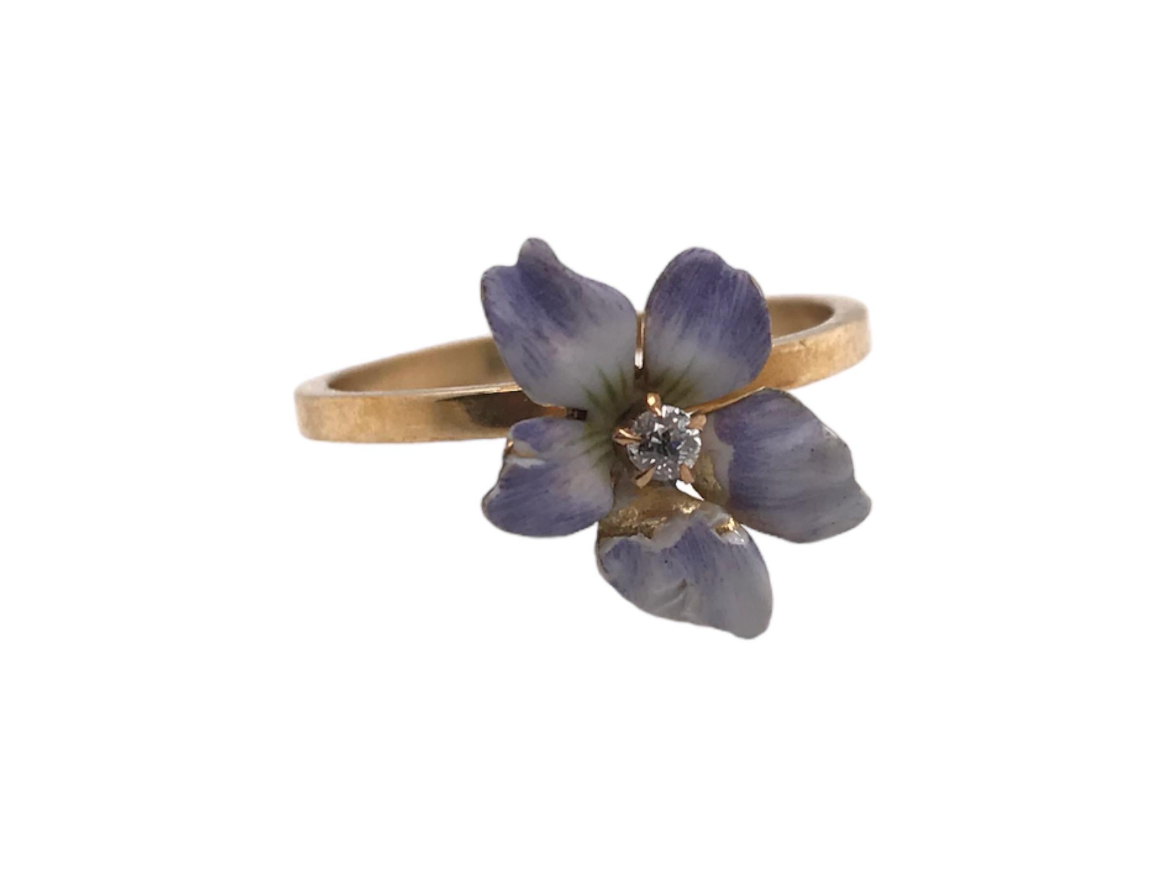 We love great conversion pieces such as this!
Originally a stick pin & repurposed into a dainty fashion ring.
This beauty features magnificent enamel work along with a tiny diamond in the center of the flower.

Metal: 10K Yellow Gold
Shank Width: