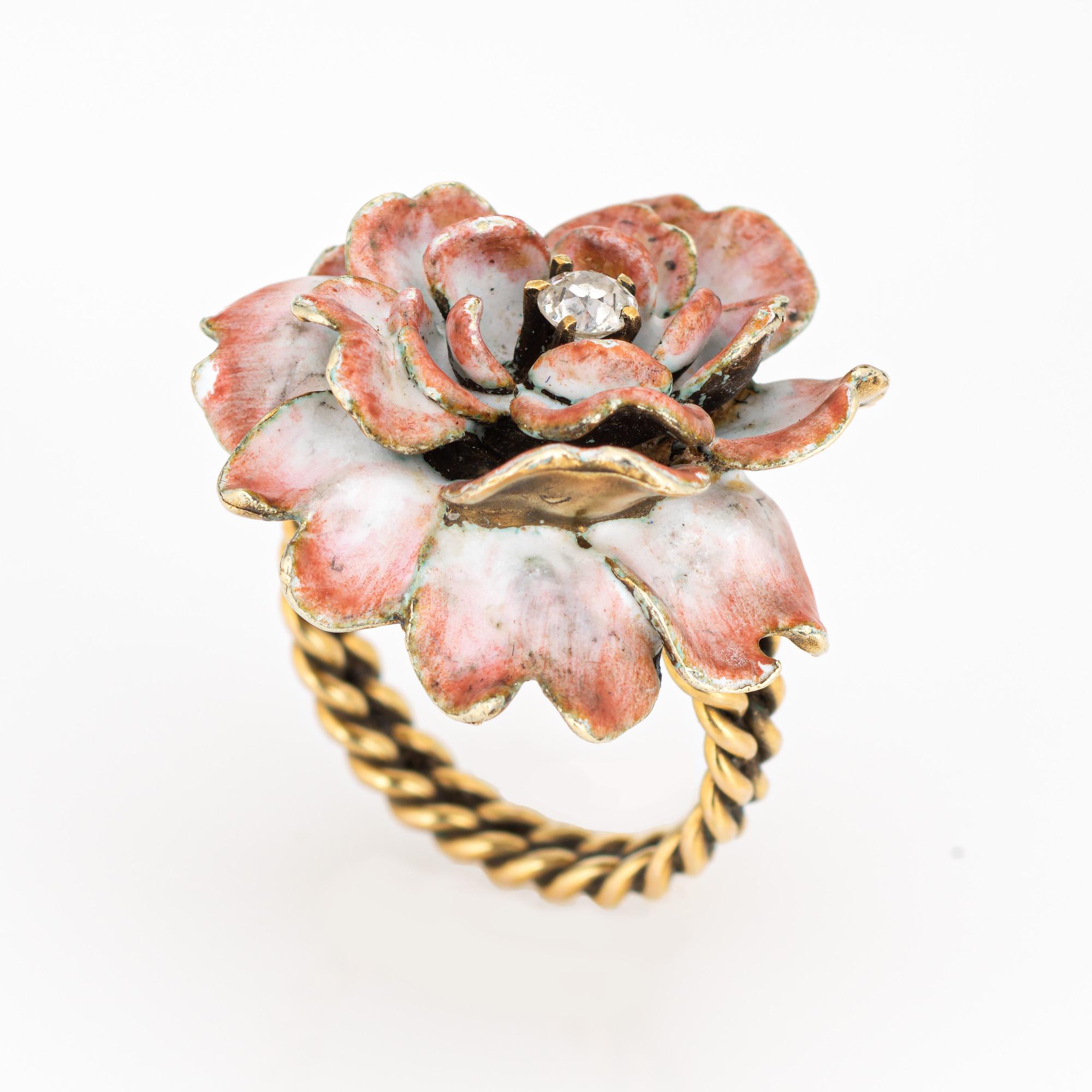 Stylish vintage enamel & diamond flower cocktail ring (circa 1950s to 1960s) crafted in 14 karat yellow gold. 

Old mine cut diamond is estimated at 0.10 carats (estimated at I-J color and SI2 clarity). The enamel is in good condition with some loss