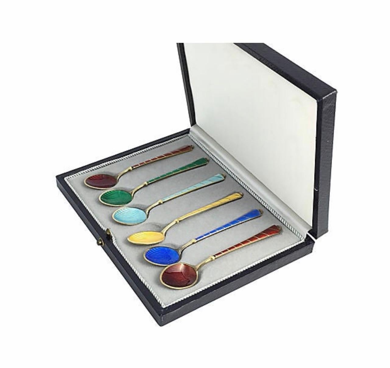 Boxed set of 6 Egon Lauridsen (ELa Denmark) gilded silver & enamel demitasse spoons manufactured in Copenhagen between 1936-1966. These stunning gilt sterling silver coffee spoons are enameled in vibrant colors. (Both the stems and the bowls are
