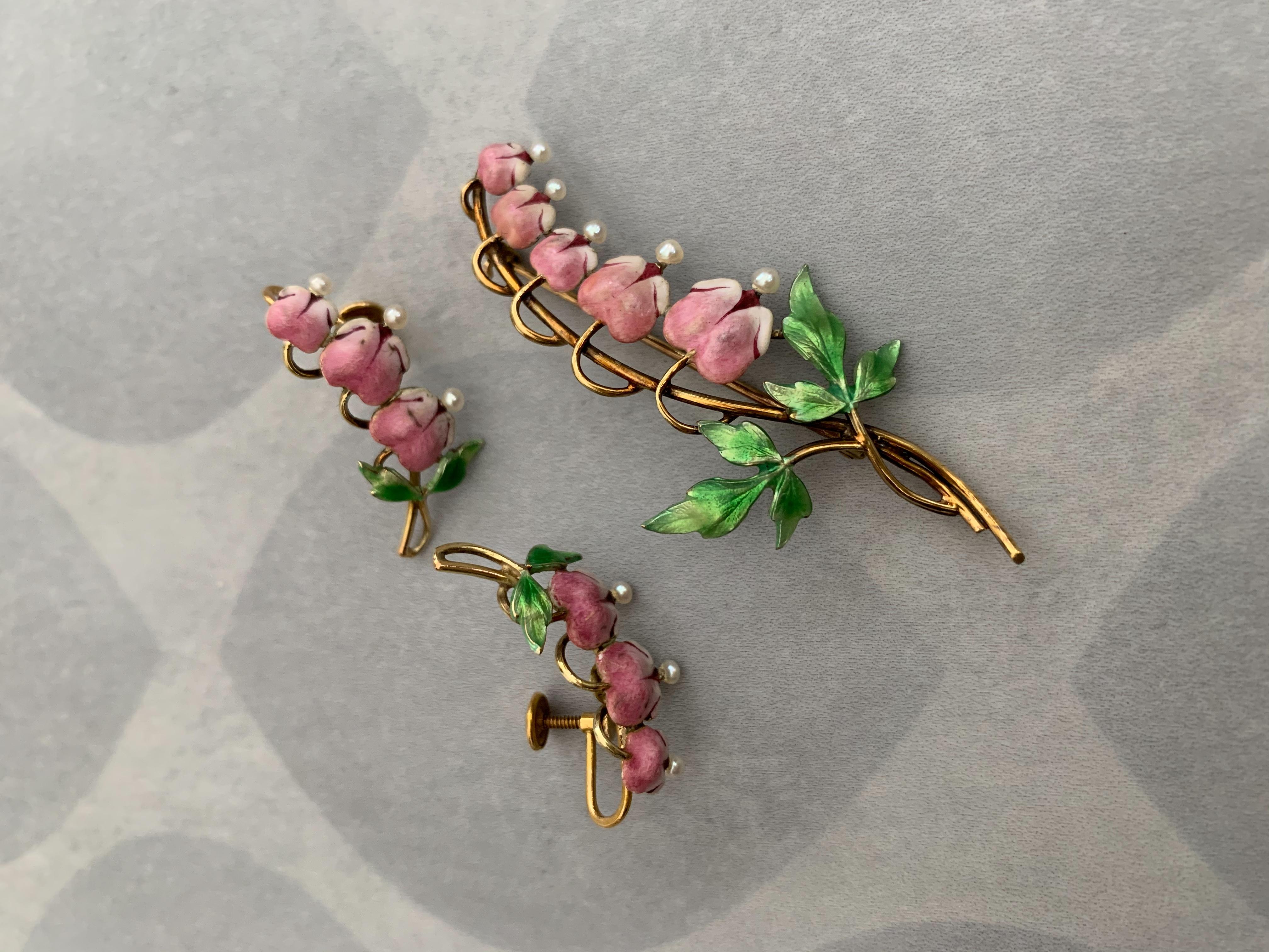 This is such a lovely brooch and earrings set designed to look like delicate Bleeding Heart flowers.  These pieces are hand painted enamel with Pearl accents. The enamel is in good condition on all three pieces.  

Measurements:
Earrings: 1