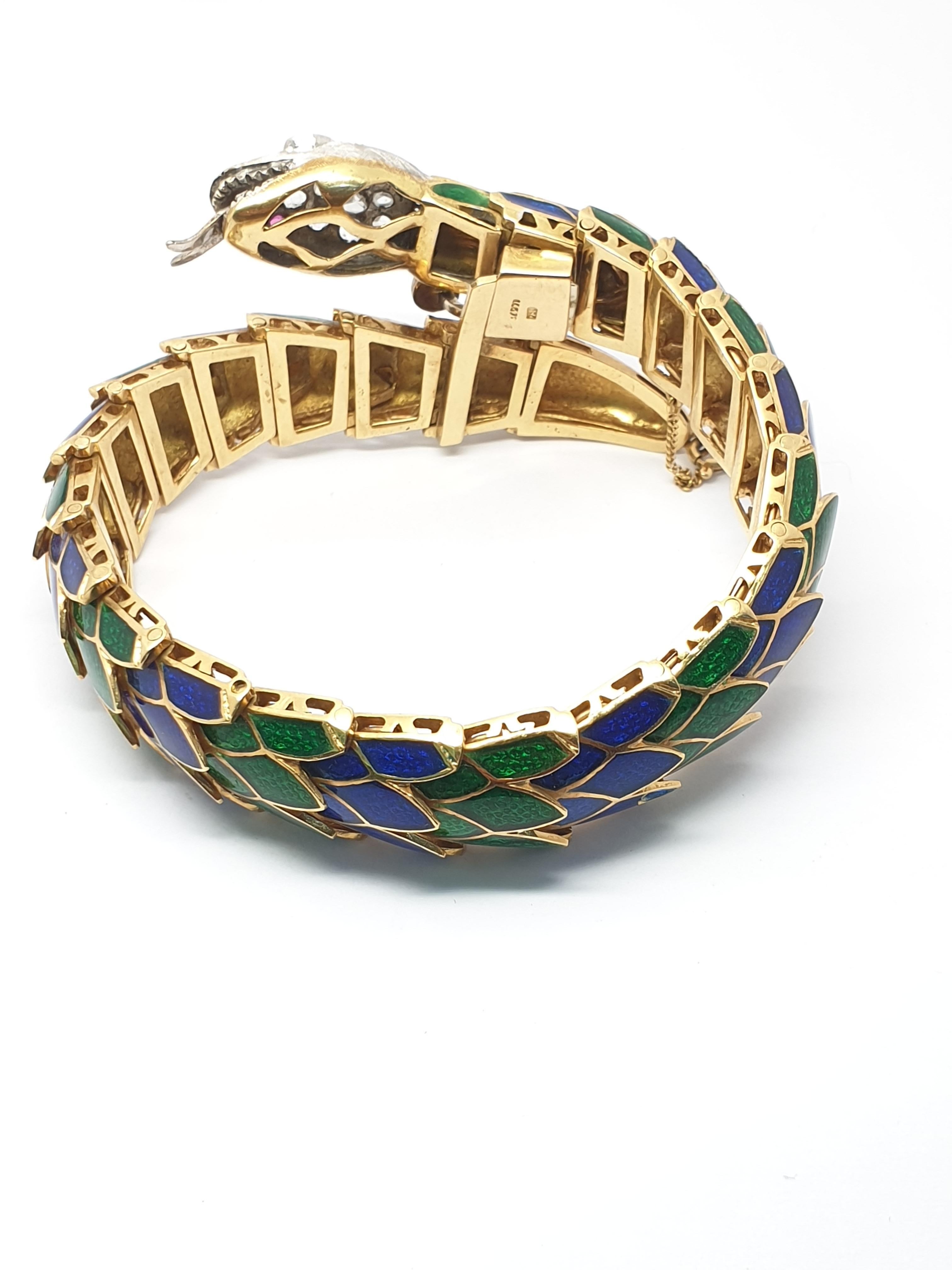 Antique style  snake bracelet was made in Italy probably in the 1970's. The vibrant color of blue and green enameling made by a high skilled goldsmith.(enamel shows some loss small areas).The flexible joints move well and give a comfortable feeling