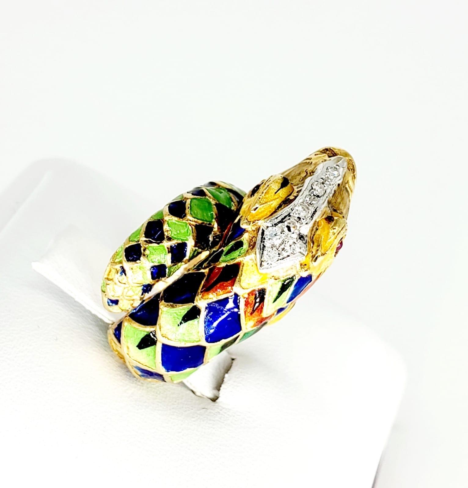 Vintage Enamelled Old Mine Cut Diamonds Snake Ring. The ring features red ruby cabochon eyes as well as approx 0.10 carats of old minded diamonds on the head of the snake. The ring is made of 18k solid yellow good with beautiful enamel around the