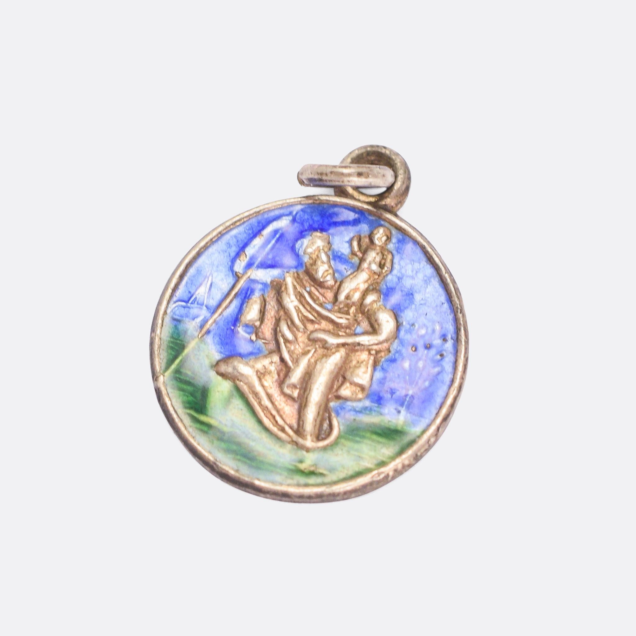 A sweet vintage St. Christopher charm modelled in sterling silver and finished in bright blue and green enamel. With clear English hallmarks from 1964.

MEASUREMENTS 
1.7 x 1.4cm

WEIGHT 
1.6g

MARKS 
English hallmarks for Sterling Silver,