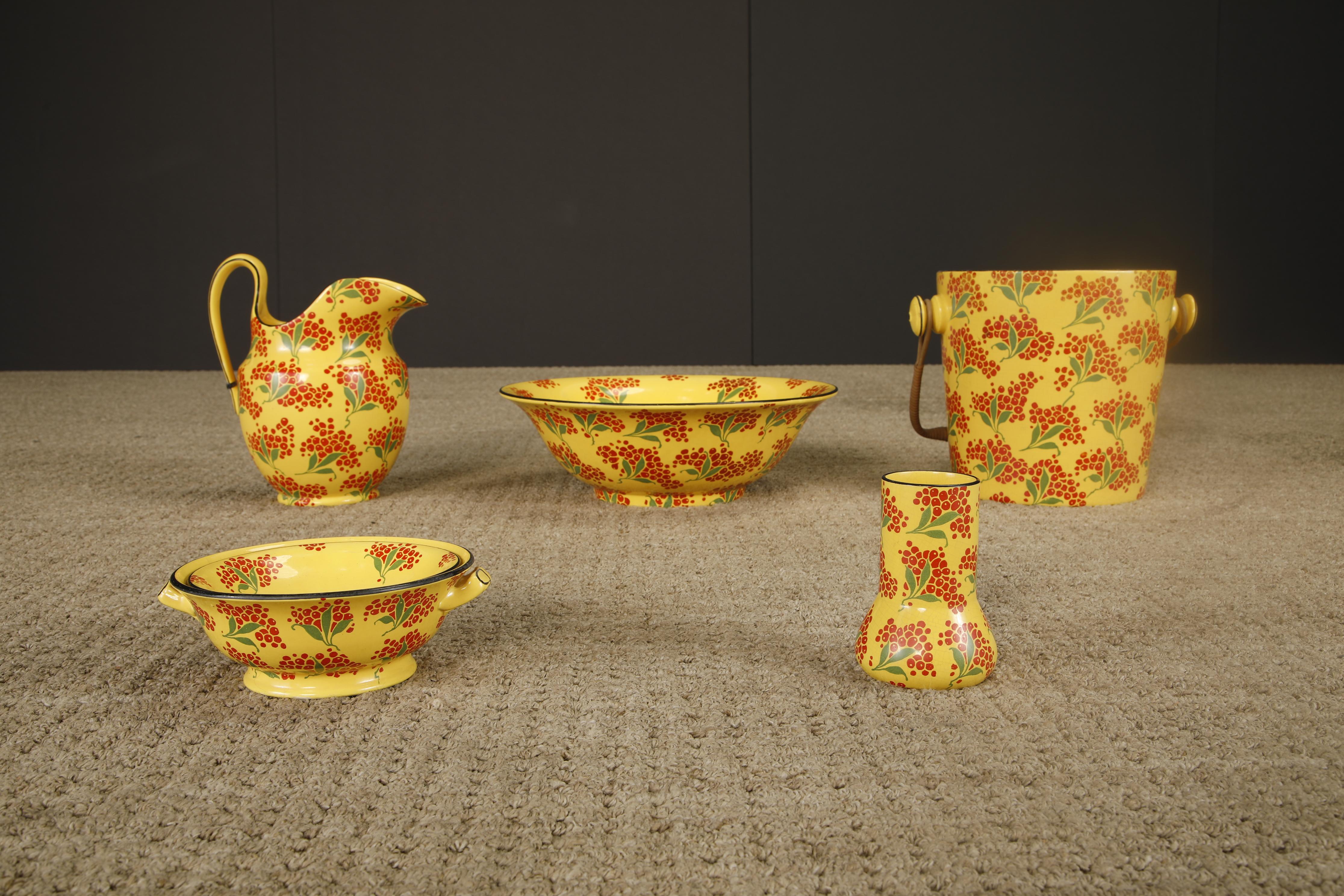 This charming mid-century enamelware wash set is a vibrant tribute to the decorative housewares of the 1950s to 1960s. Featuring a coordinating pitcher, basin, ice bucket, small vase, and strainer colander, the set is unified by a sunny yellow