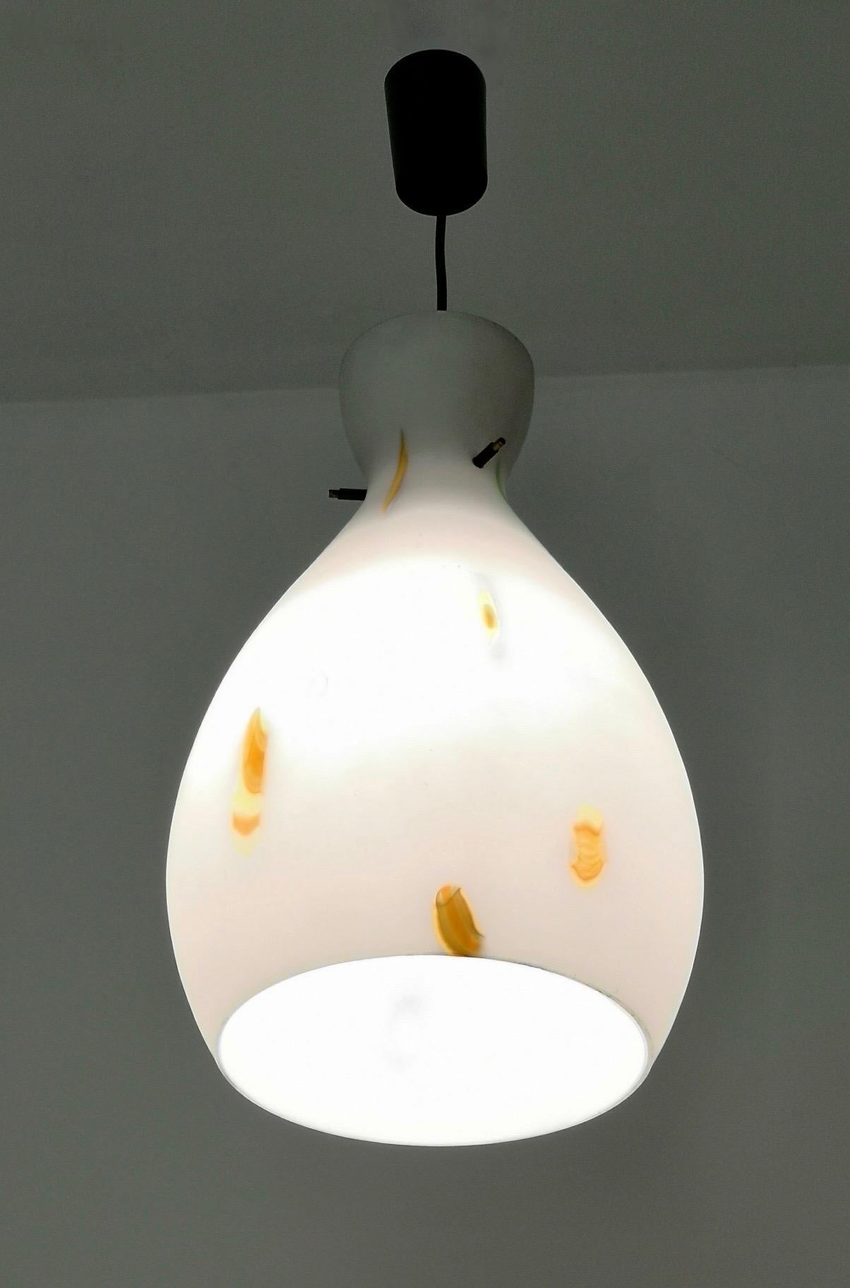 Made in Italy, 1950s.
This pendant features an encased and blown glass lampshade with orange murrine.
It might show slight traces of use, but it can be considered as in excellent original condition and ready to give ambiance to any room.

Measures: