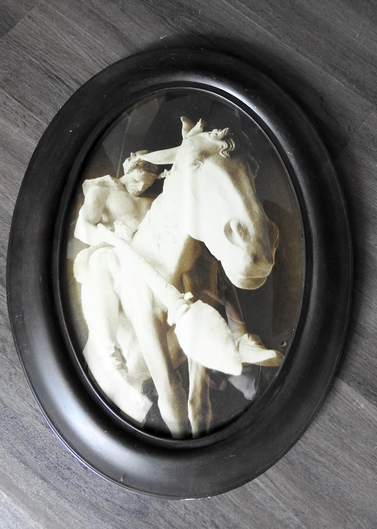 Unusual perspective photographic print of the statue End of the Trail Native American on horseback. Displayed under domed glass in oval vintage frame, scuffing to frame.
