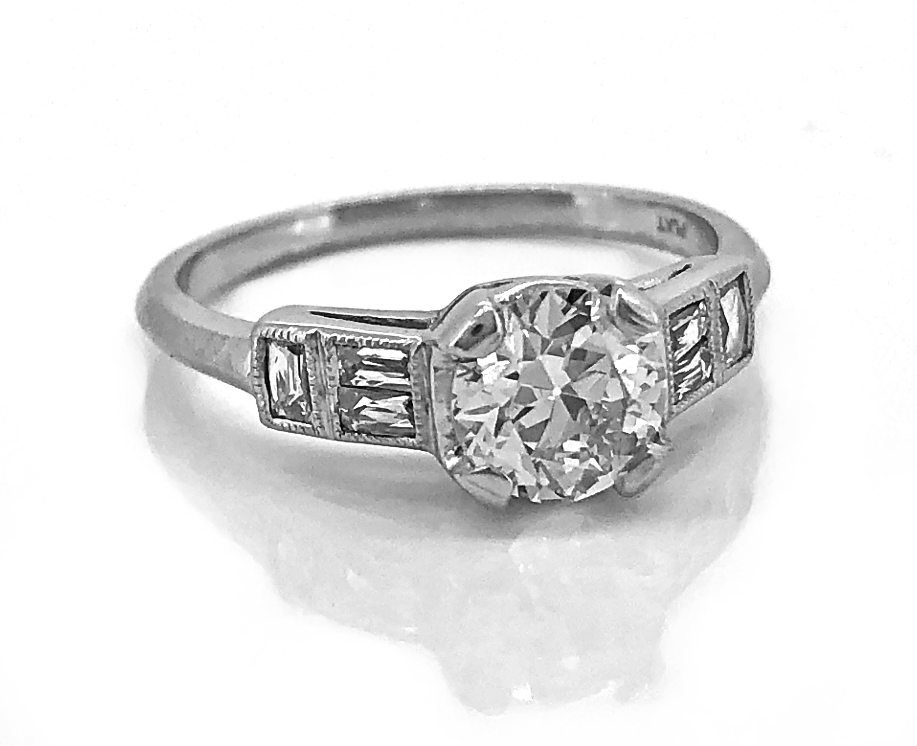 An Art Deco style vintage engagement ring featuring a .85ct. European cut center diamond crafted in platinum. The color is J with SI1 clarity. The accenting .40ct. apx. T.W. of French cut baguette diamonds give it the unique design that is beautiful