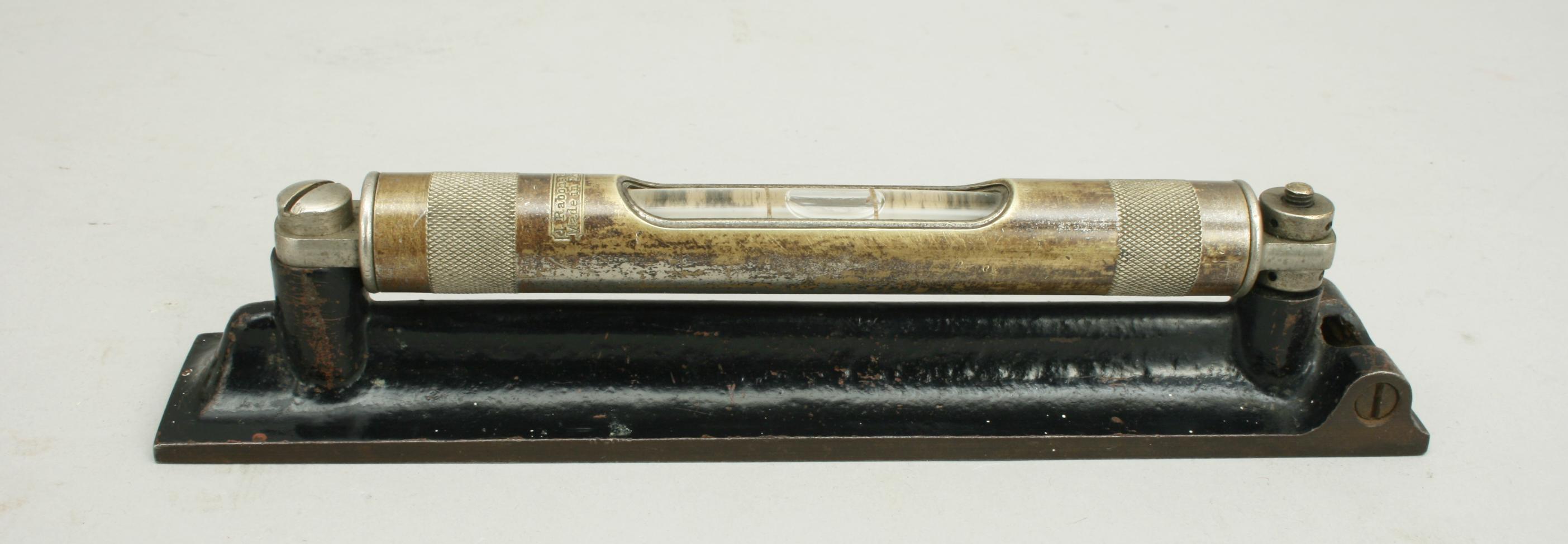 J. Rabone & Sons Engineers Spirit Level.
A vintage brass engineers spirit level made in England by John Rabone & Sons, Birmingham. This early 20th century level has a swivel cover to protect the glass tube and is mounted onto a cast iron base. The