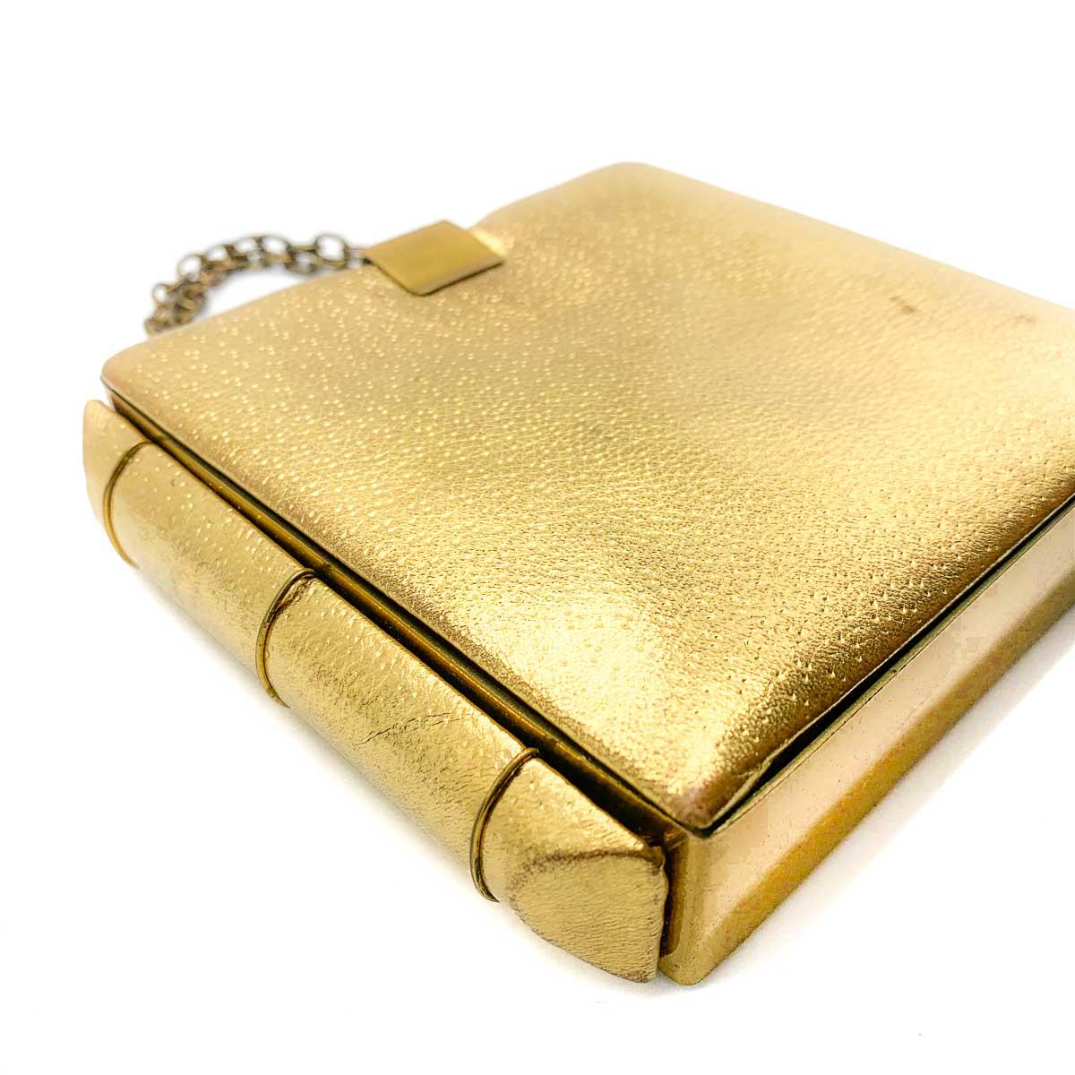 A Vintage Art Deco Gold Bookend Minaudiere. A stunning find from the 1930s Art Deco period. A minaudiere box style evening purse finished with book-end sides. Crafted in the most wonderful gold leather with finished brass hardware. The interior