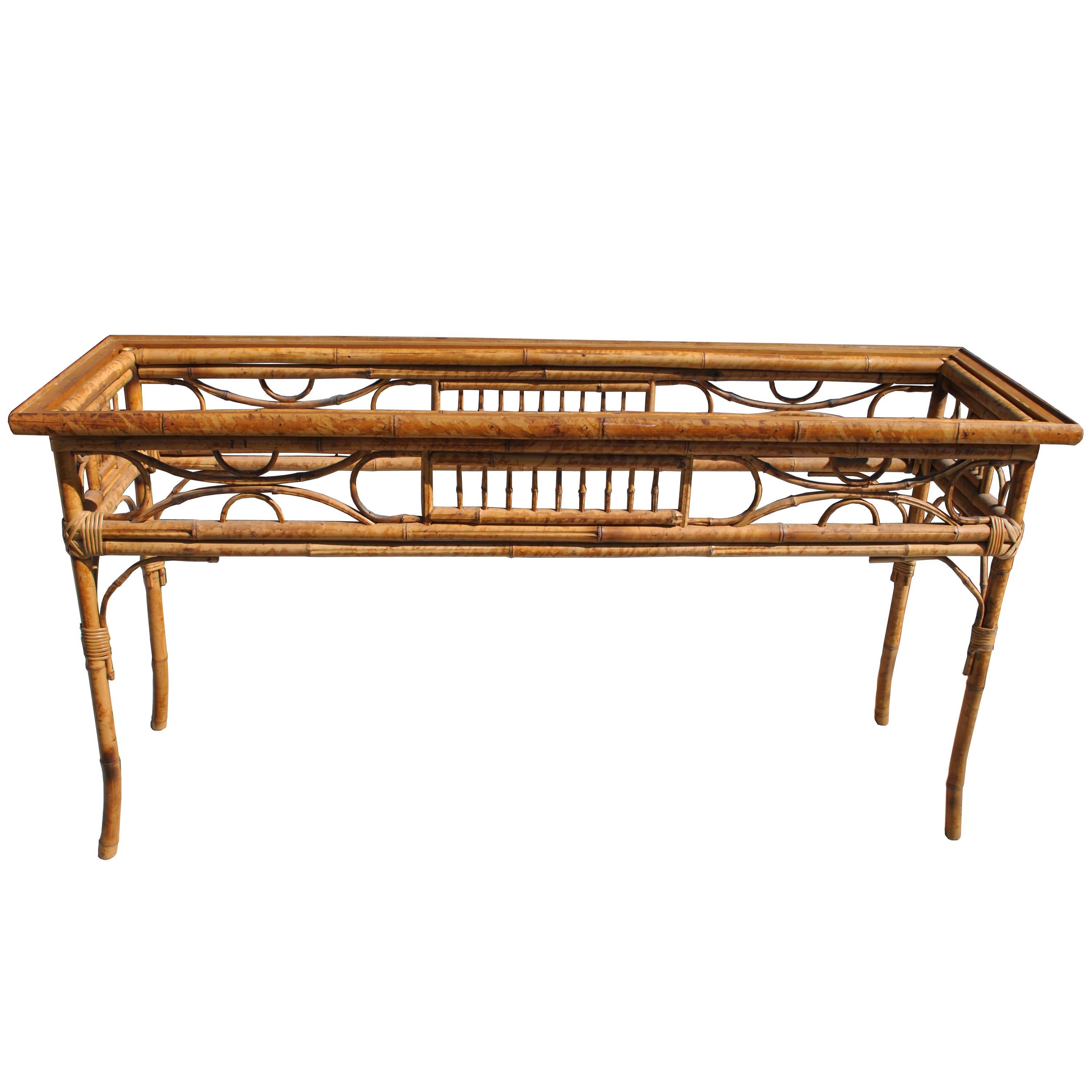 1960s rattan console with intricate detailing and a light tortoise shell finish. 

 