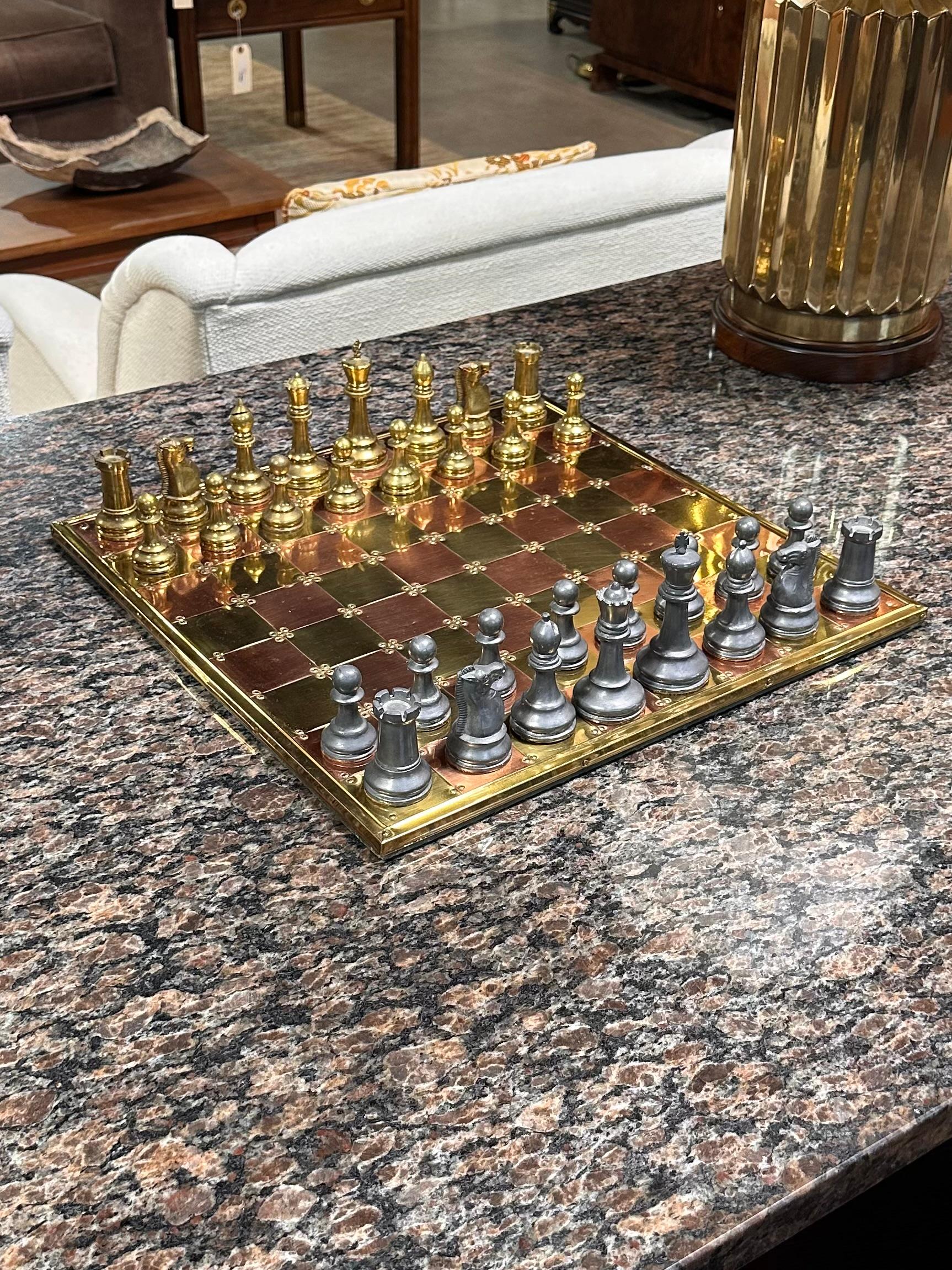 Vintage English Brass, Copper, and Pewter Chess Set

This is a very fine English brass, copper, and pewter gaming set, dating to the late 20th century, circa 1980. The chess board is constructed of 64 copper and brass squares, each with a shimmering