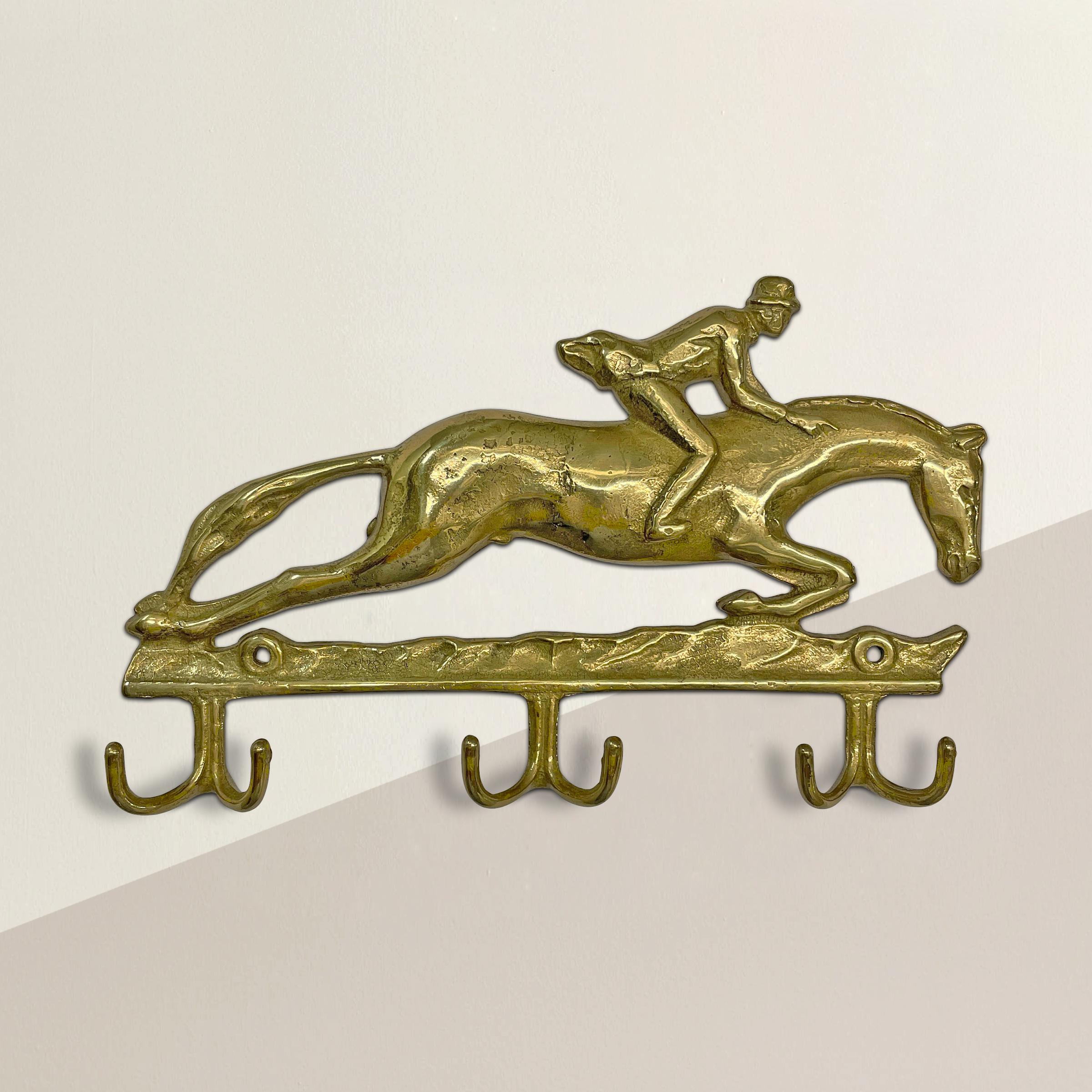 A playful vintage English brass wall hook with a horse and rider, perfect for hanging your purses, coats, necklaces, neckties, or your dog's leashes!