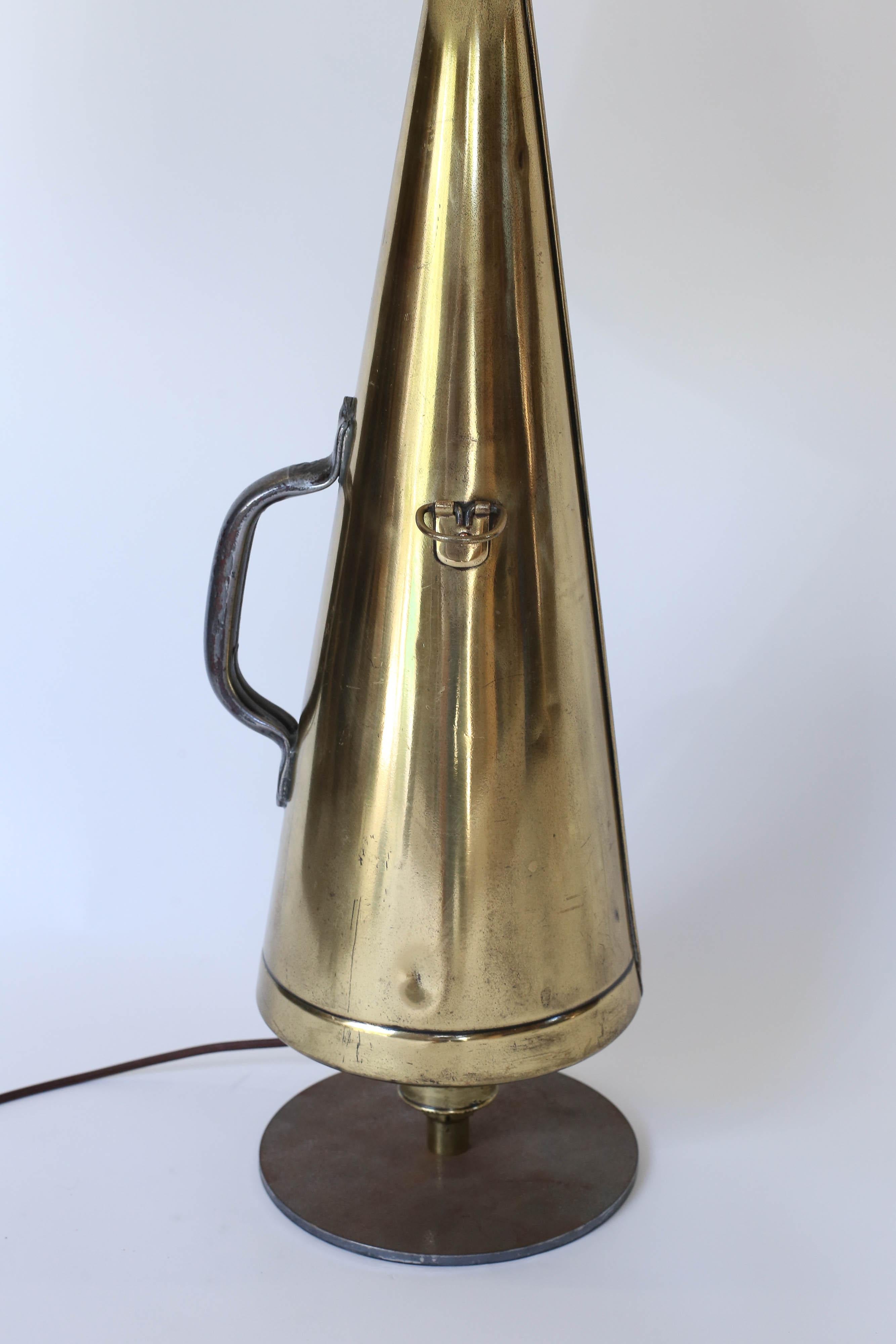 Found in England and newly wired in the United States, a vintage brass megaphone repurposed as a table lamp. In the shape and style of the Classic brass megaphone used on British sailing vessels this table lamp is sure to delight.