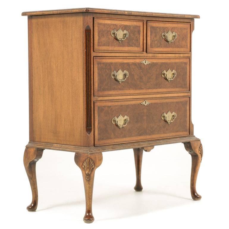 An English, mid-20th century, Queen Anne-style, four-drawer chest in burl walnut, the drawers and top with herring bone inlay and banded edges, circa 1960.





    