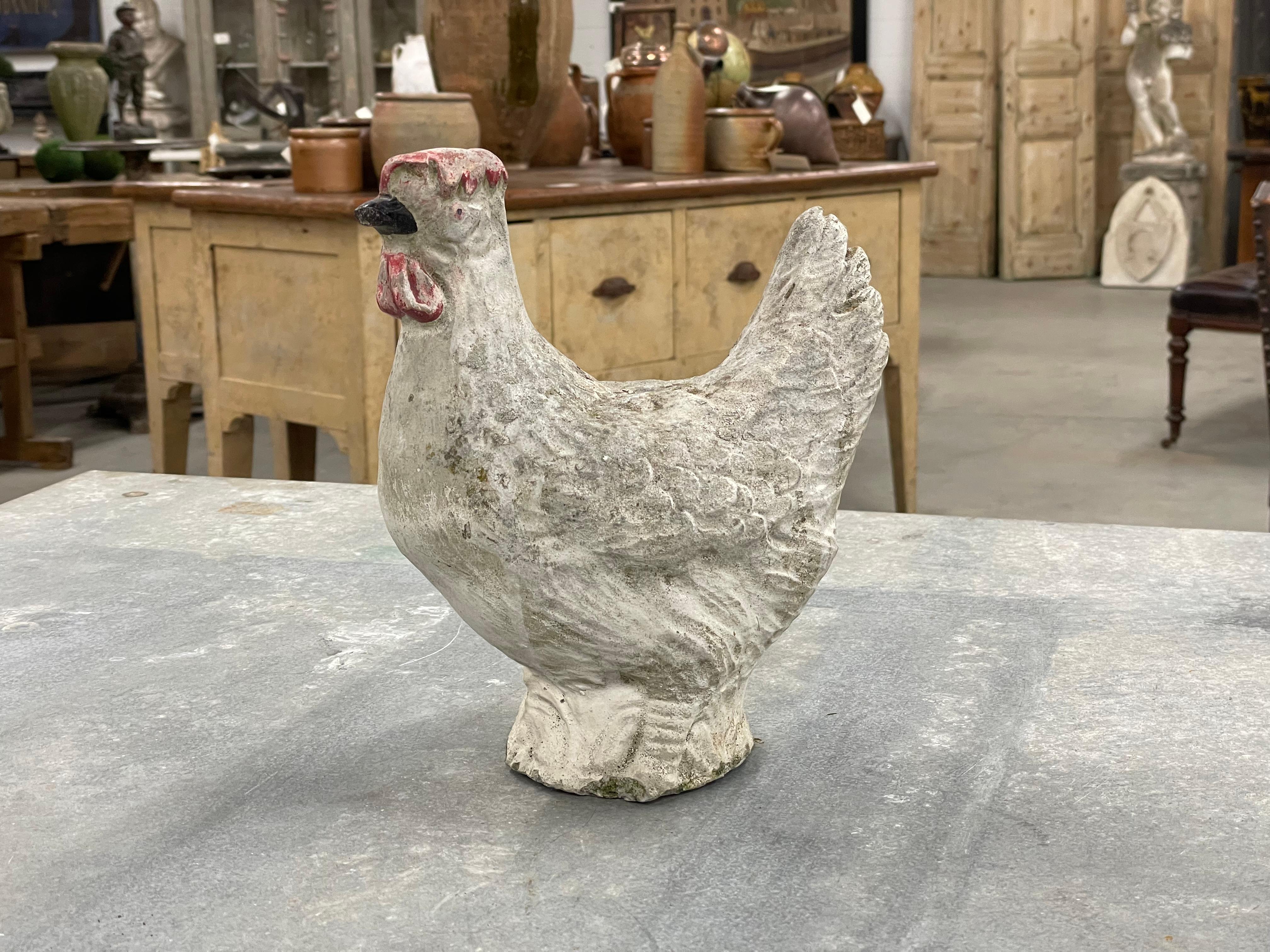 Vintage English cast stone rooster with remnants of its original paint. It has aged beautifully over the decades which has left a lovely patina. 

A quirky and charming addition to a home or garden. 