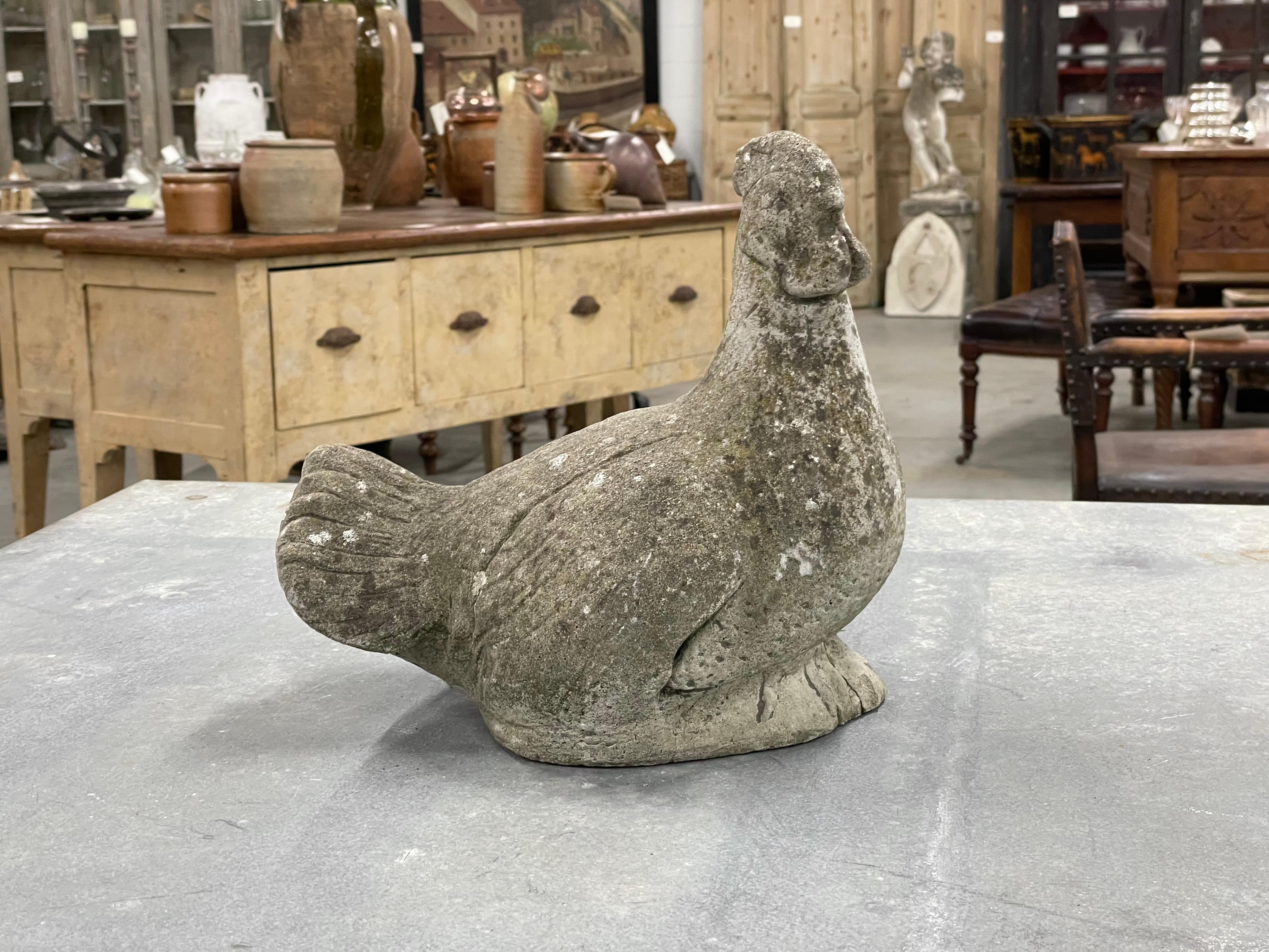 Vintage English cast stone recumbent rooster which has aged beautifully over the decades leaving a lovely patina. 

A quirky and charming addition to a home or garden. 