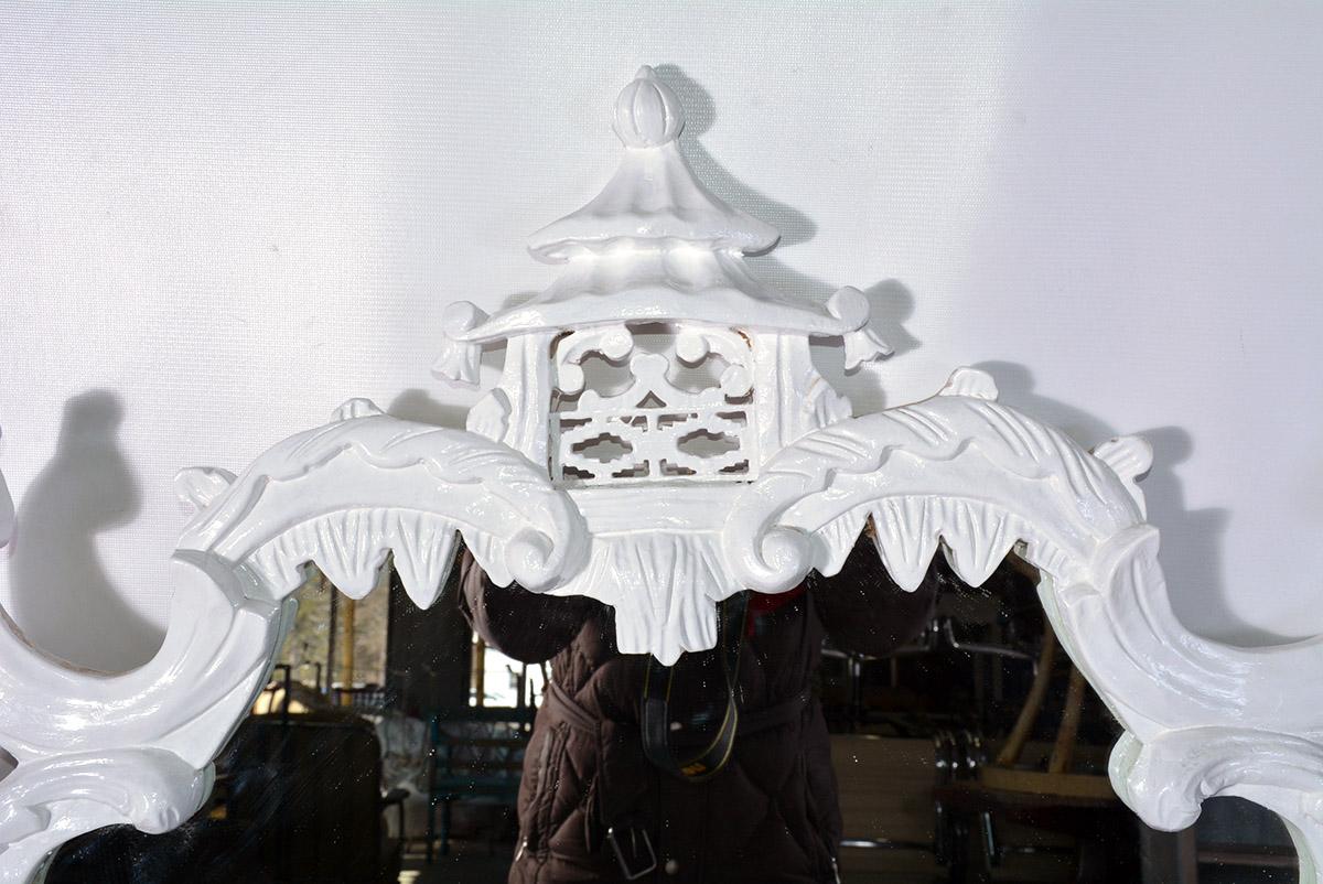 The vintage white English Chippendale style from the designer's Rococo period. Fantastical birds on each side and a pagoda at the top enhance the design. The mirror will make a major statement in the hall, dining room or living room. Wired for