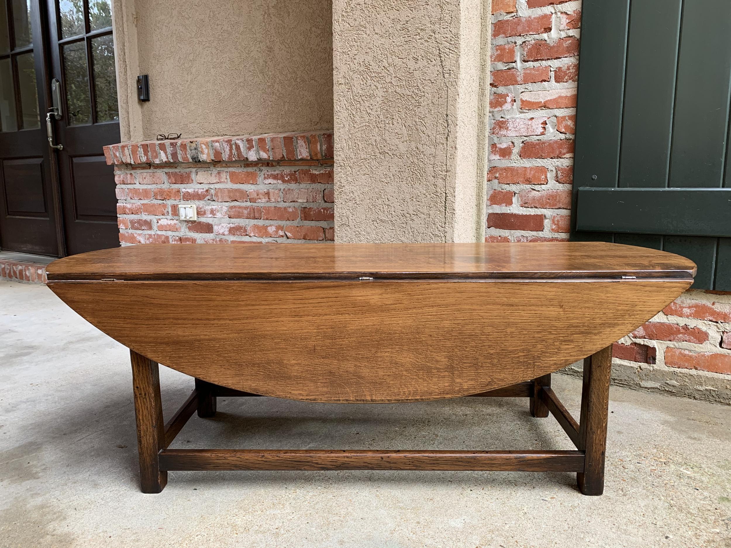 Vintage English coffee table slender drop leaf wake table oval mid century

~Direct from England~
~Lovely silhouette on this vintage English coffee table~
~Long and slender, in a traditional “wake table” design, with two drop leaves that can