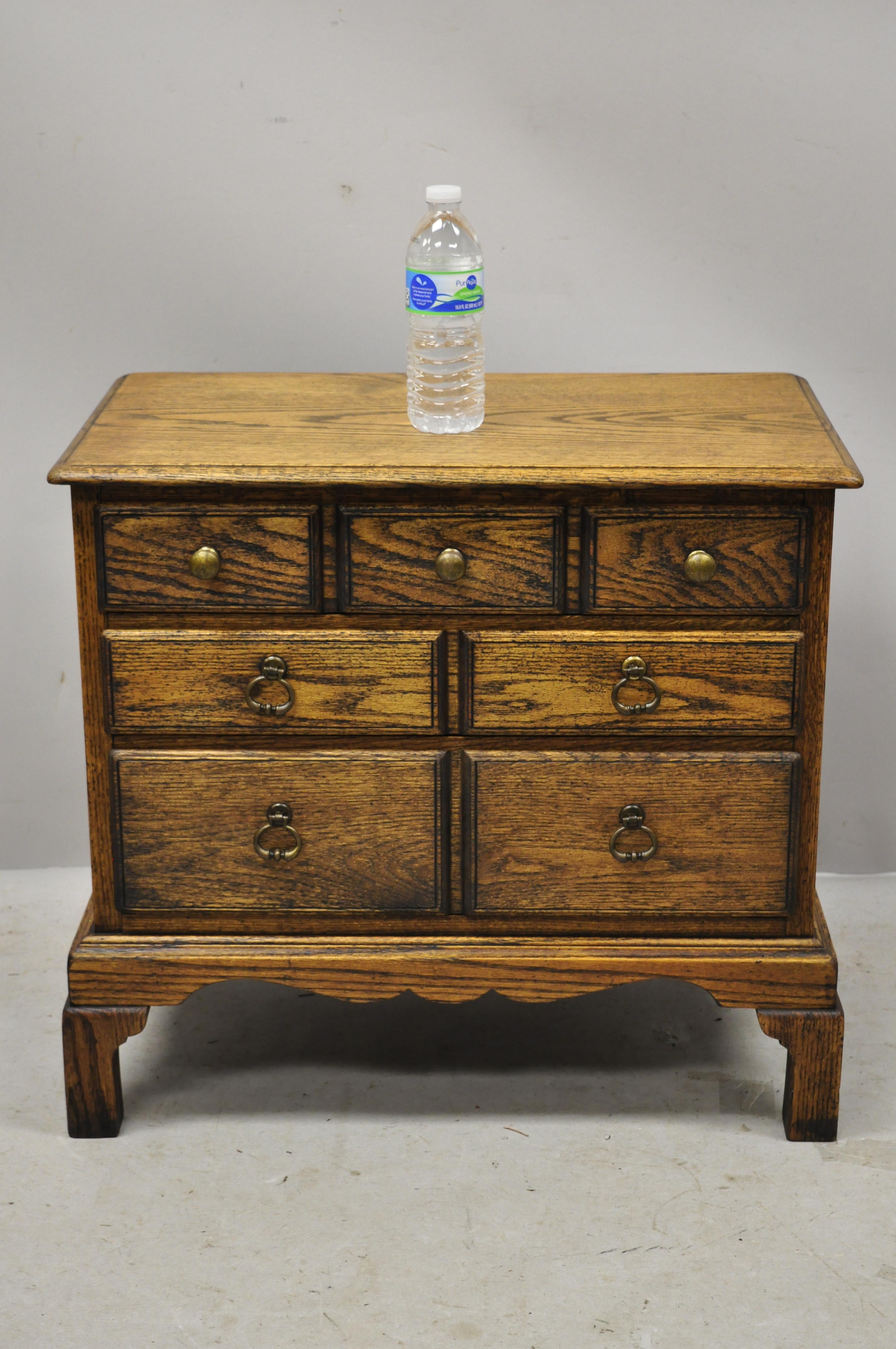 Vintage English Colonial Style Small Miniature Oak Wood Campaign Chest Side Table. Item features solid wood construction, beautiful wood grain, 3 dovetailed drawers, solid brass hardware, quality American craftsmanship. Circa Mid 20th Century.