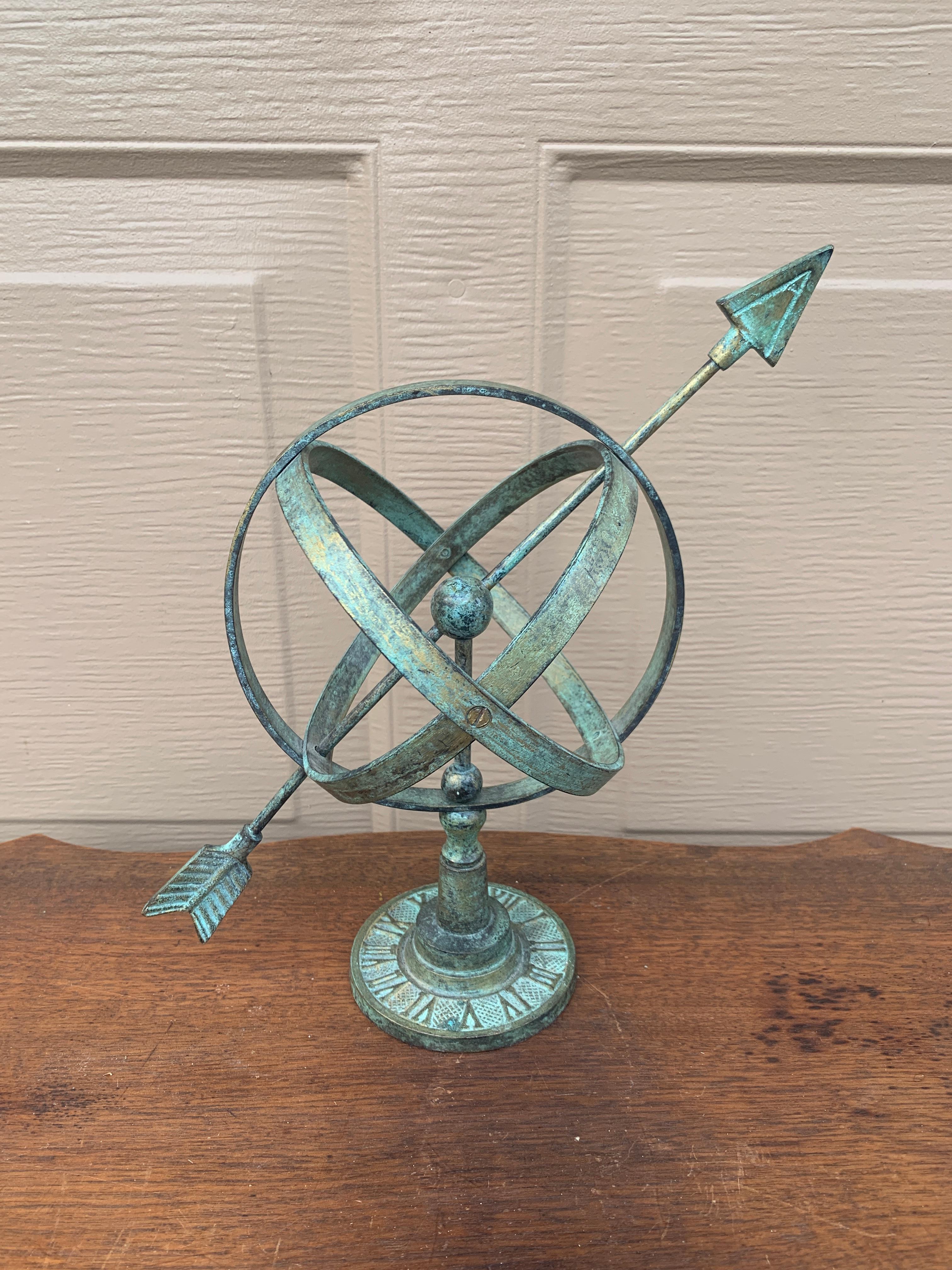 A stunning vintage English country or Neoclassical style green brass verdigris garden armillary sundial with Roman numerals

USA, Late 20th Century

Measures: 10