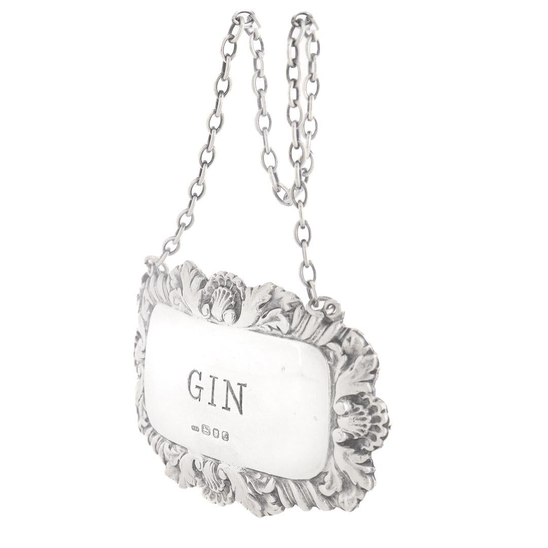A fine vintage English Gin decanter or liquor label.

In sterling silver.

By Richards & Knight. 

The octagonal silver label hangs on a chain and reads: WHISKY

Marked with English hallmarks for Richards & Knight, Birmingham, Sterling, 1975.