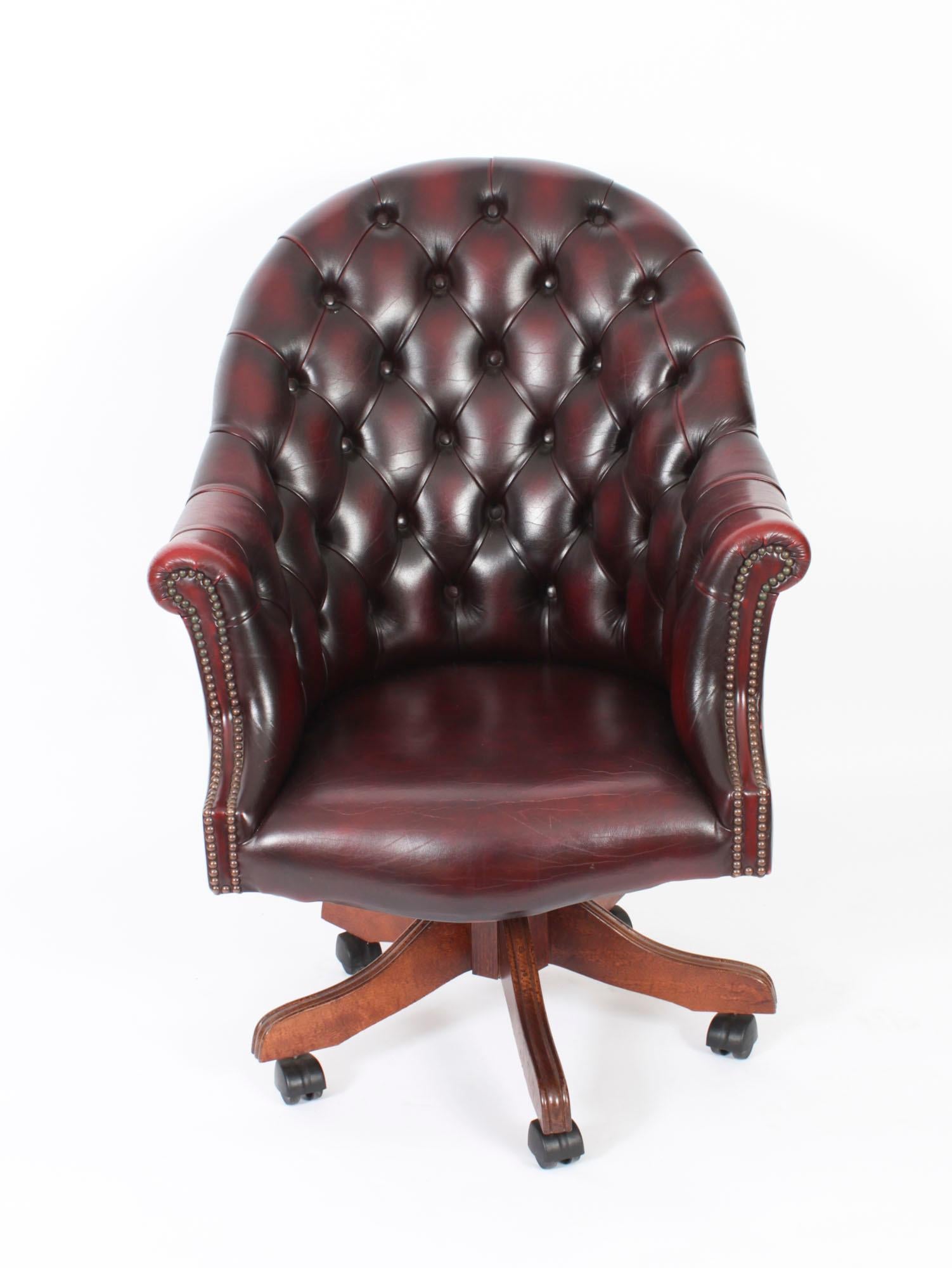 An absolutely stunning vintage leather 'Director's chair' with button back in a beautiful burgundy colour, hand-made in England with materials of the finest quality, dating from the late 20th Century.

Height is adjustable with a swivel/tilt