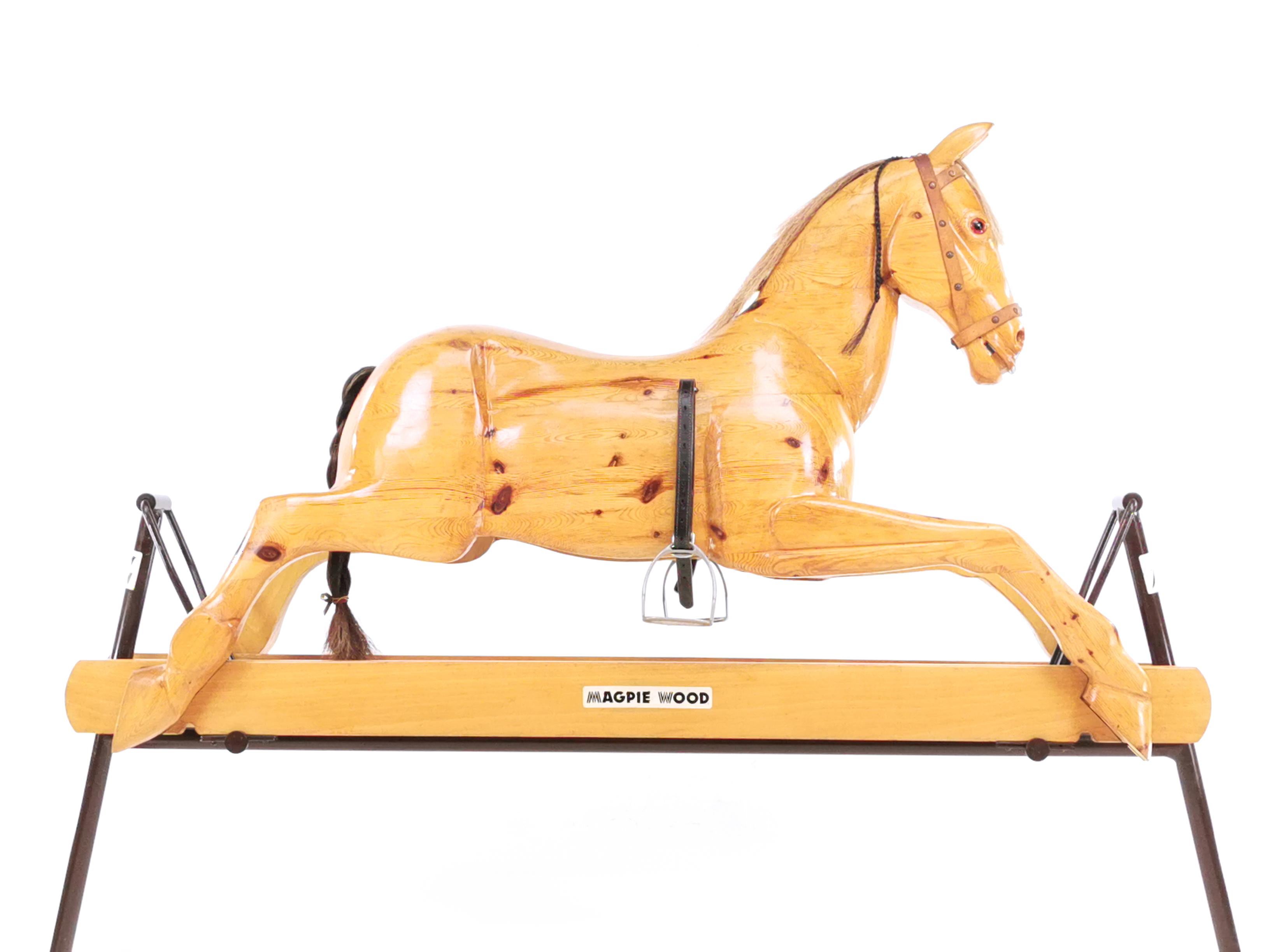 Vintage rocking horse

A beautiful rocking horse by Magpiewood, dated mid-late 20th century rocking, complete horsehair mane and tail and glass eyes, sits on a raised on a metal frame and adjustable stirrups. English made and labelled by the maker