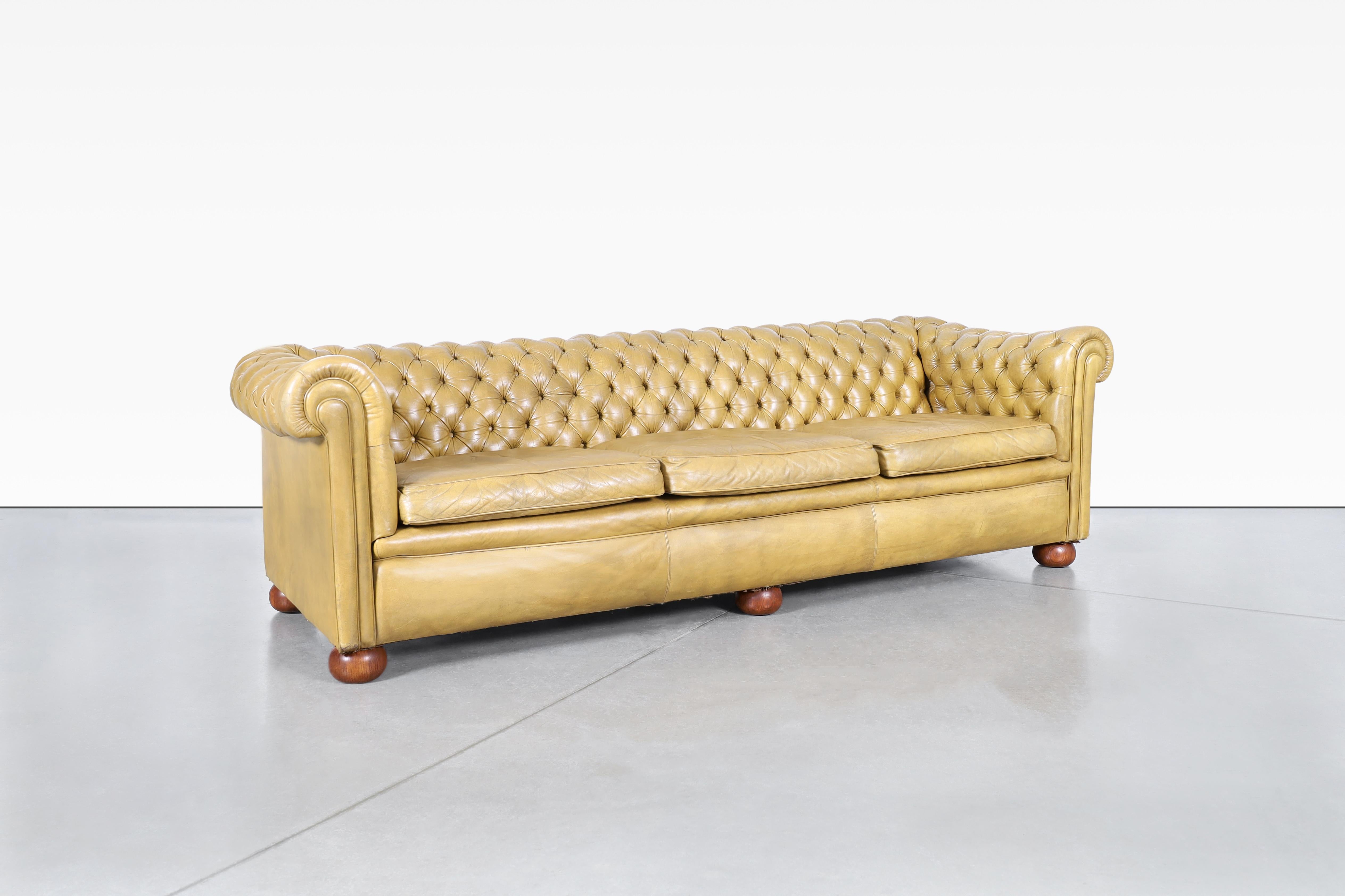 Discover the charm of this elegant vintage leather Chesterfield sofa, a true embodiment of classic British craftsmanship from the 1950s. Its striking design features deep tufted diamond upholstery that adds depth and character to your living space.