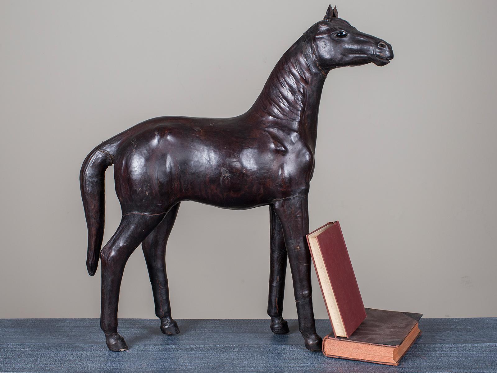 The superb pose of this vintage English thoroughbred horse from England circa 1920 echoes those favoured by the Queen of England. This example is sheathed entirely in leather and was made by the famed Liberty of England. Liberty of London is one of