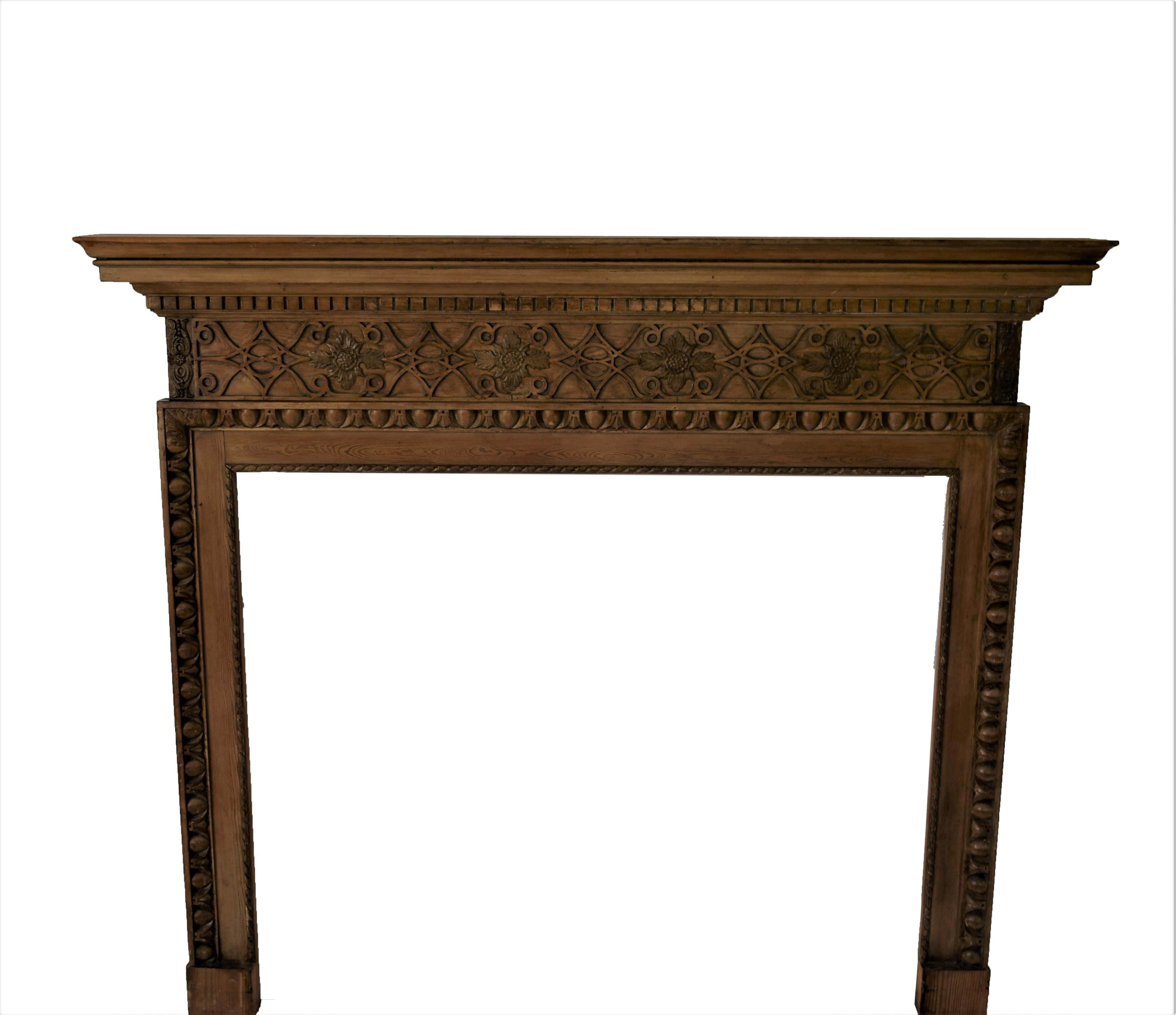 Interesting Vintage English made traditional hand carved fire surround mantel with fret work carved frieze surmounted by a dentil carved cornice. Egg & dart moulding surrounds the opening. Hand rubbed and waxed finish.

Overall - 59 1/2