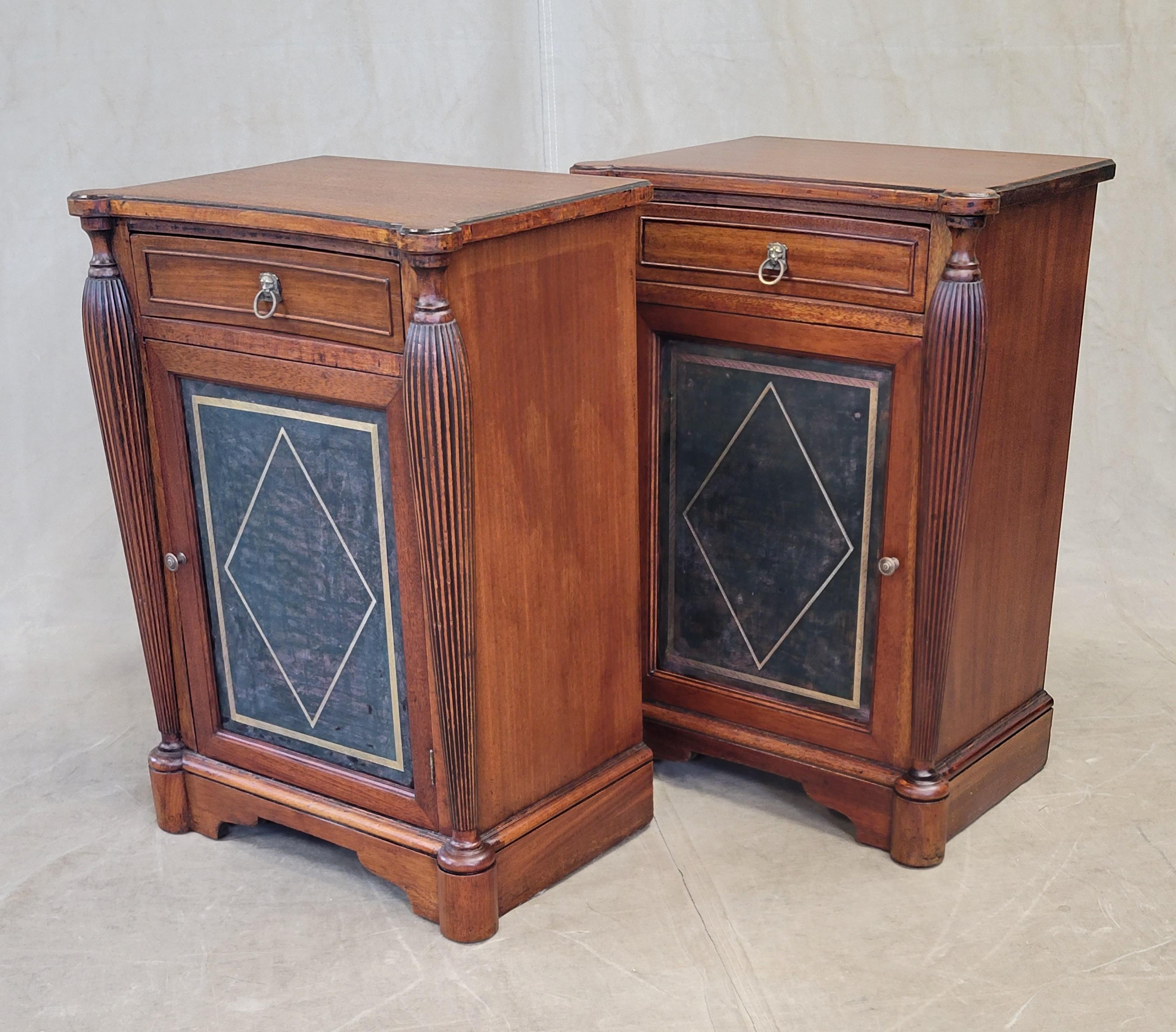 A gorgeous classic pair of vintage English mahogany nightstands with inset distressed green leather panels accented with gold embossing. Single drawer and cabinet portion with removable shelf offers a nice amount of storage. Original brass
