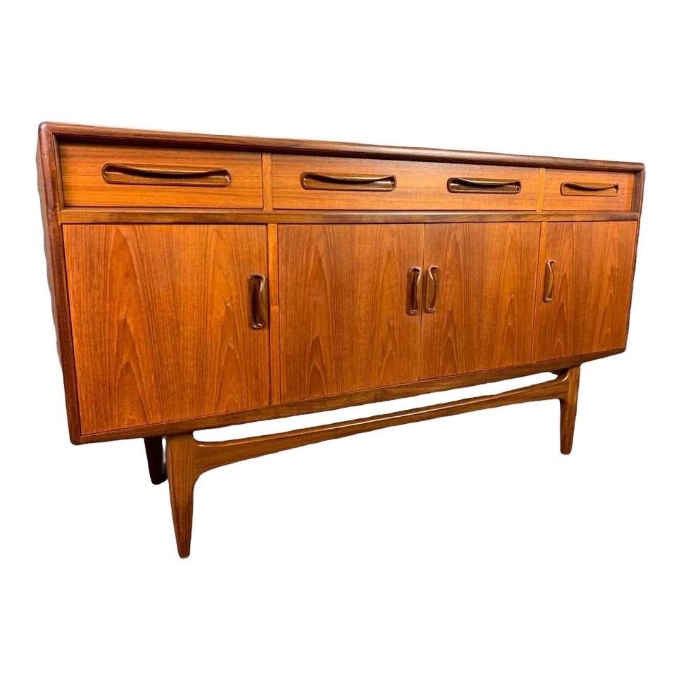 Here is a beautiful British Mid-Century Modern short sideboard in teak wood designed by Victor Wilkins part of the acclaimed 