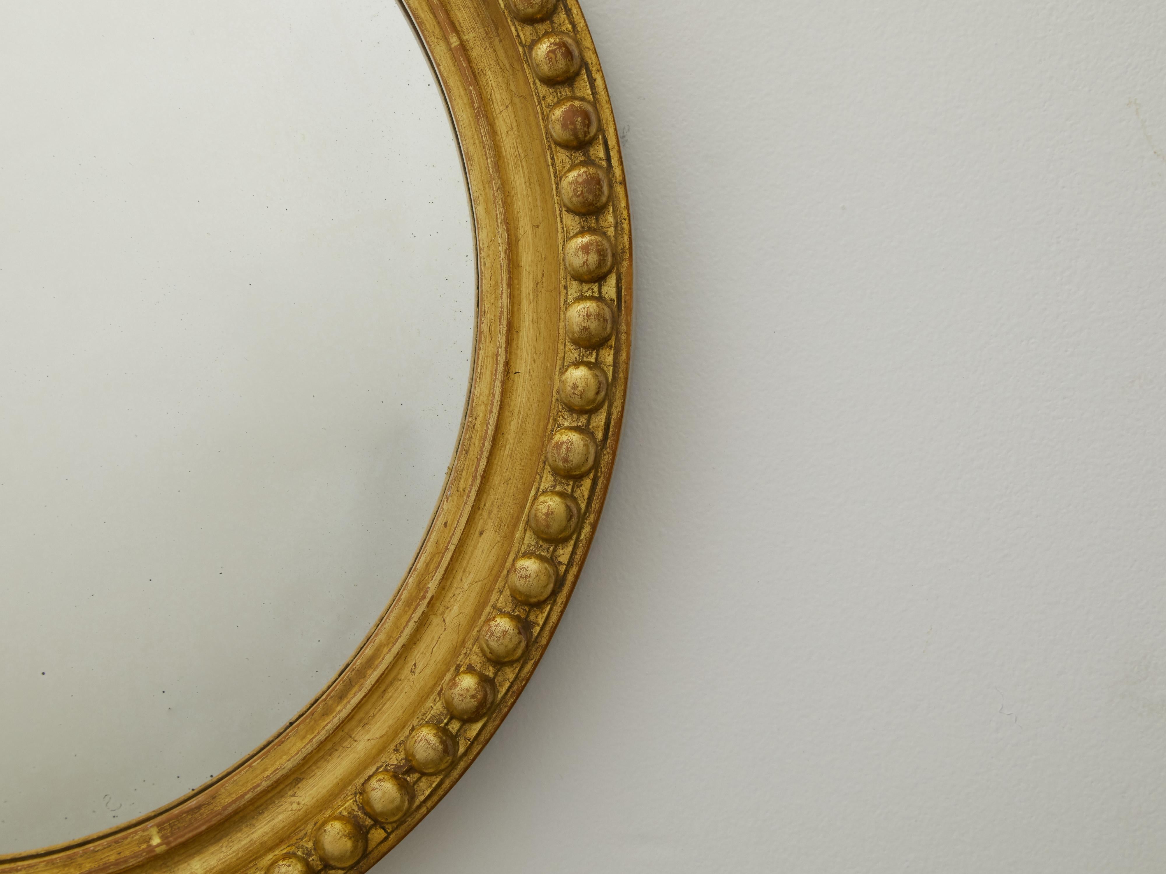 round gold beaded mirror