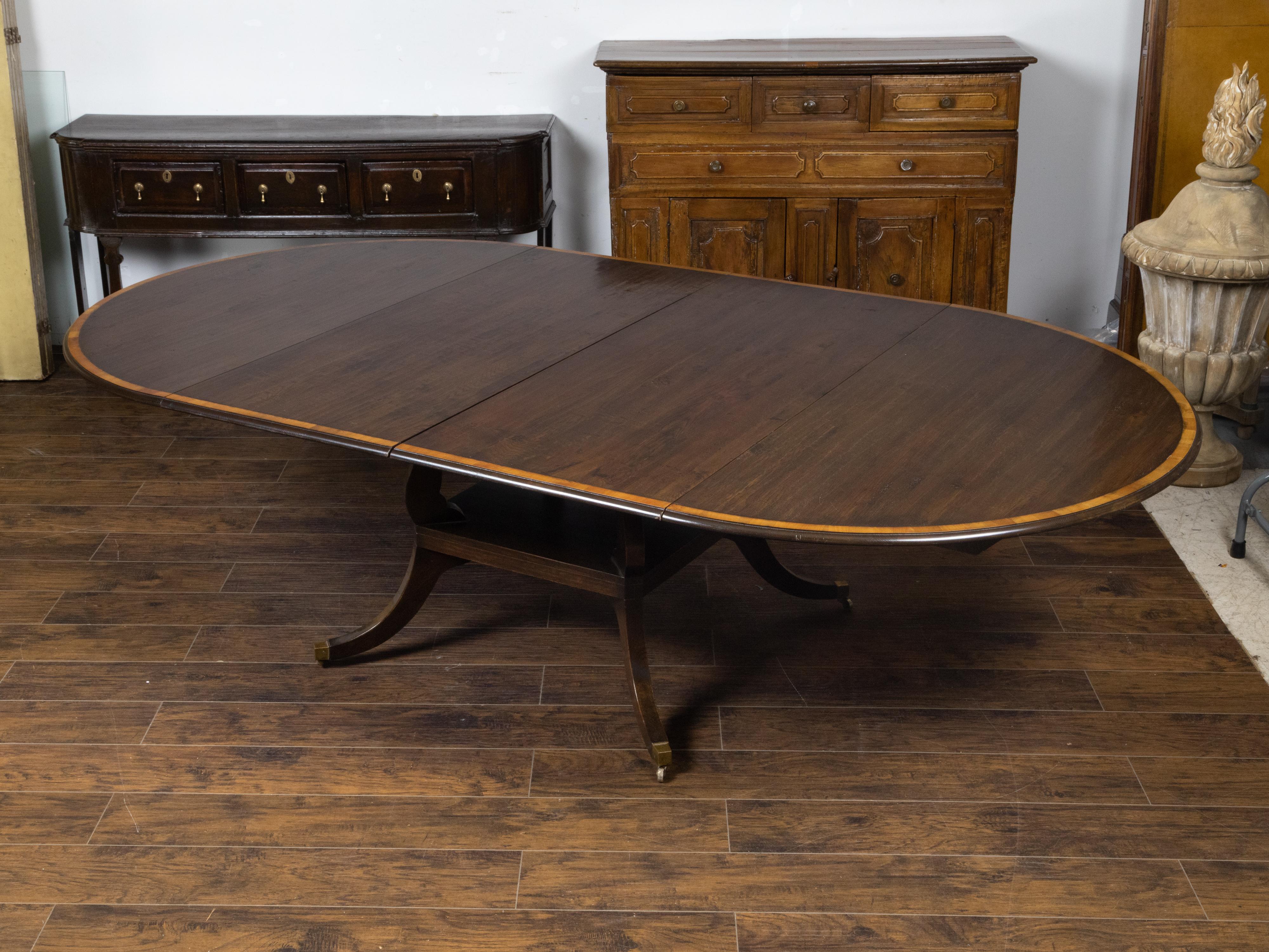 Carved Vintage English Oak Extension Table with Two Leaves and Four Legs on Casters For Sale