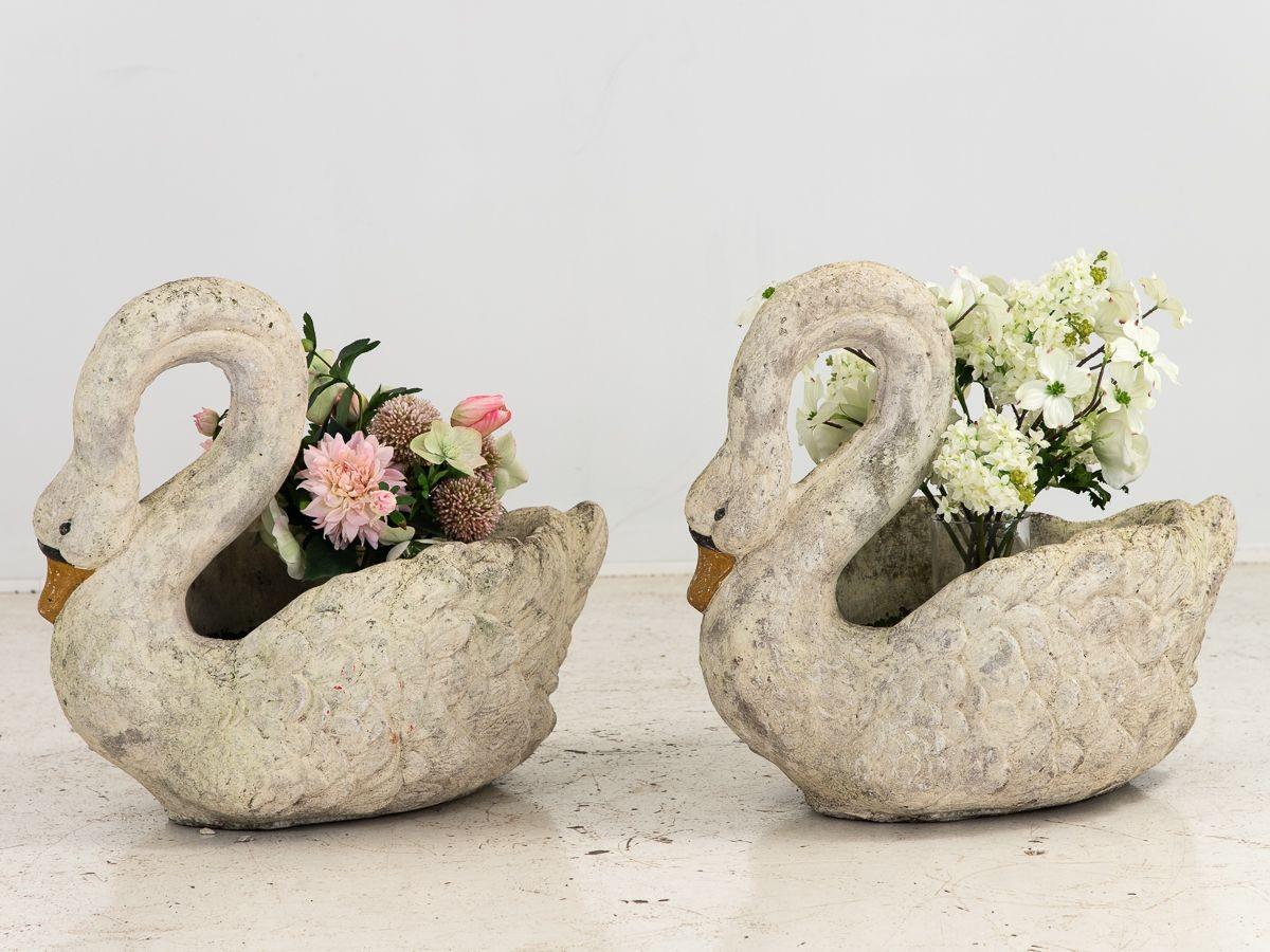 These exquisite white painted concrete swan planters capture the essence of elegance and charm. With their graceful curved necks, they exude a sense of grace and poise. The carefully applied yellow paint on their beaks adds a vibrant pop of color,