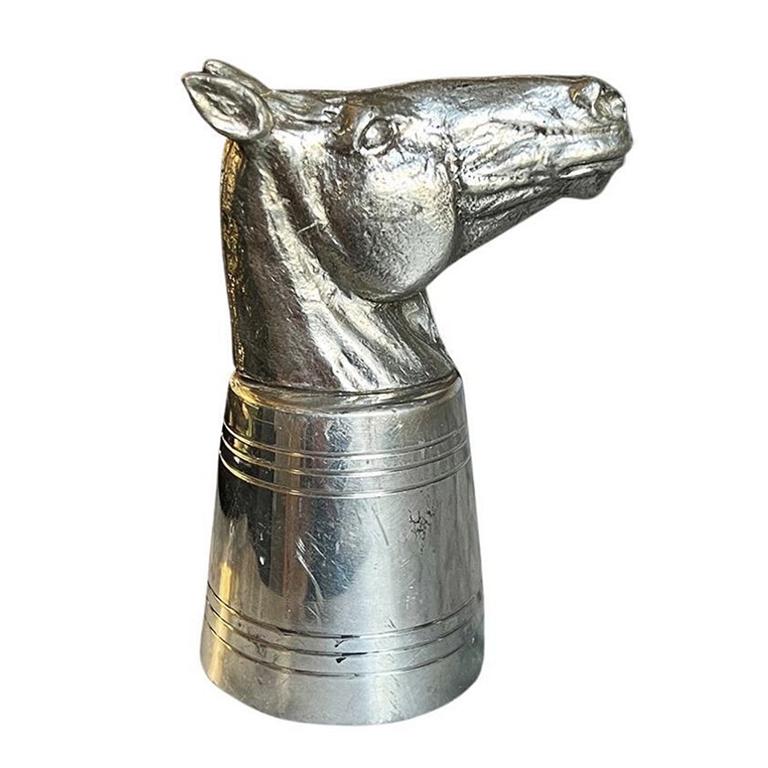 A beautiful vintage silver pewter horse head jigger. This piece will be the perfect addition to your barware. The piece is silver in color and features a large pewter horse head at the top. The bottom is an etched round pewter jigger. The piece sits