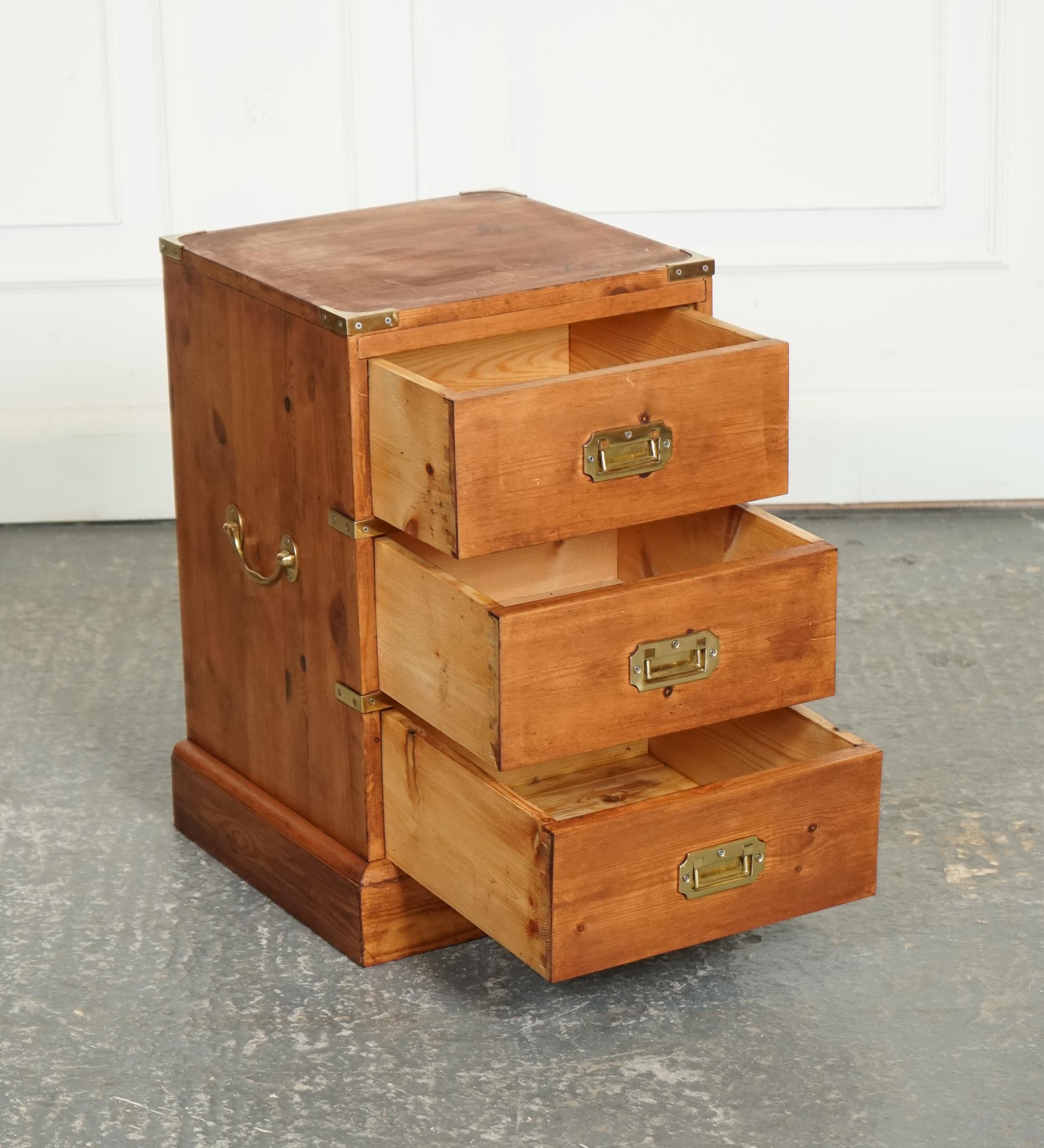 
We are delighted to offer for sale This vintage English pine military Campaign Bedside Table Nightstand.

 With drawers is a charming and versatile piece of furniture that exudes rustic elegance and historical appeal. Inspired by traditional