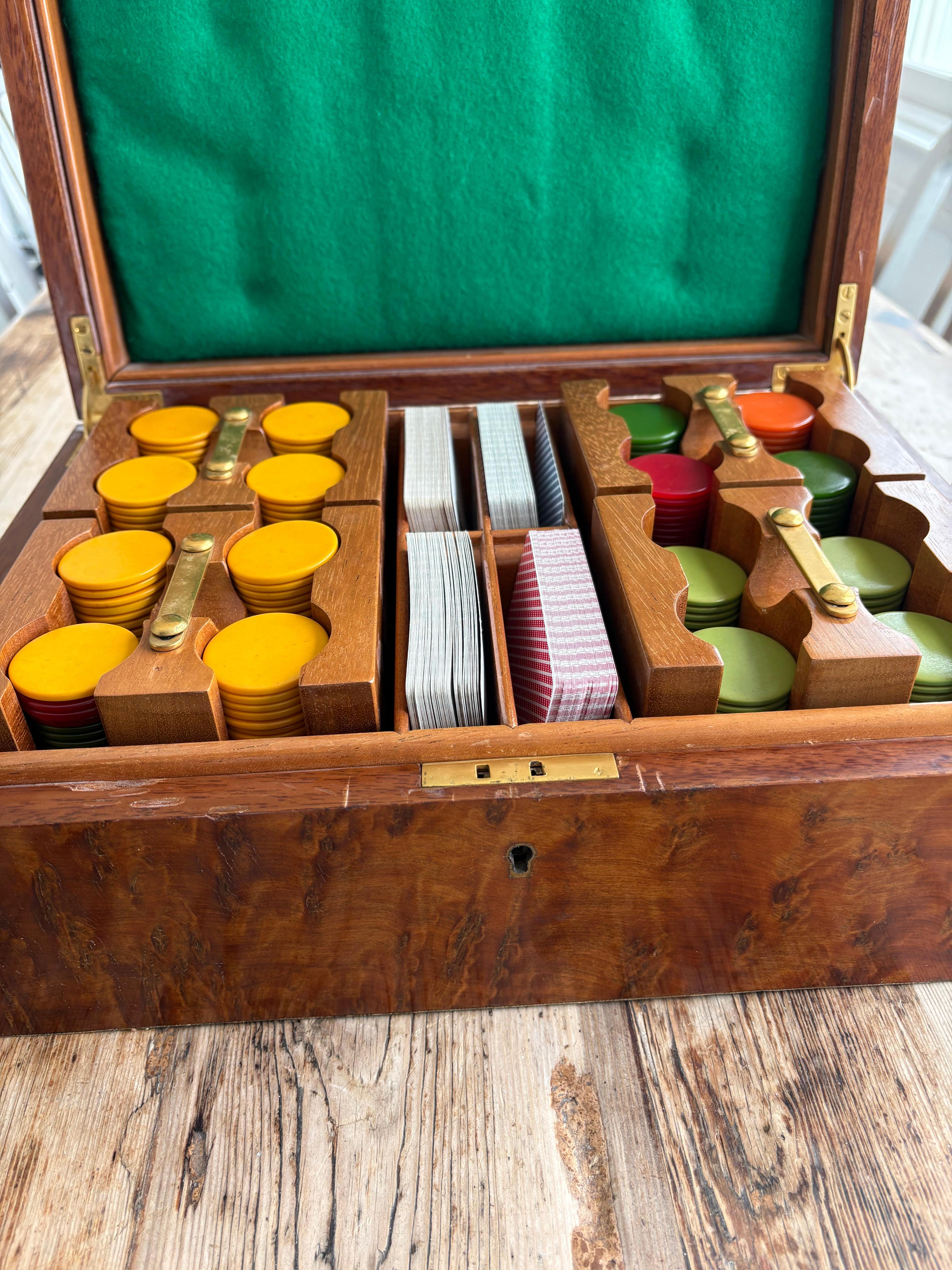 Handsome vintage poker and card set .The box and container is made of burl wood . Inside features four fitted carousel boxes that come in and out and hold all the poker chips along with two compartments for the cards. Very nicely done . Chips