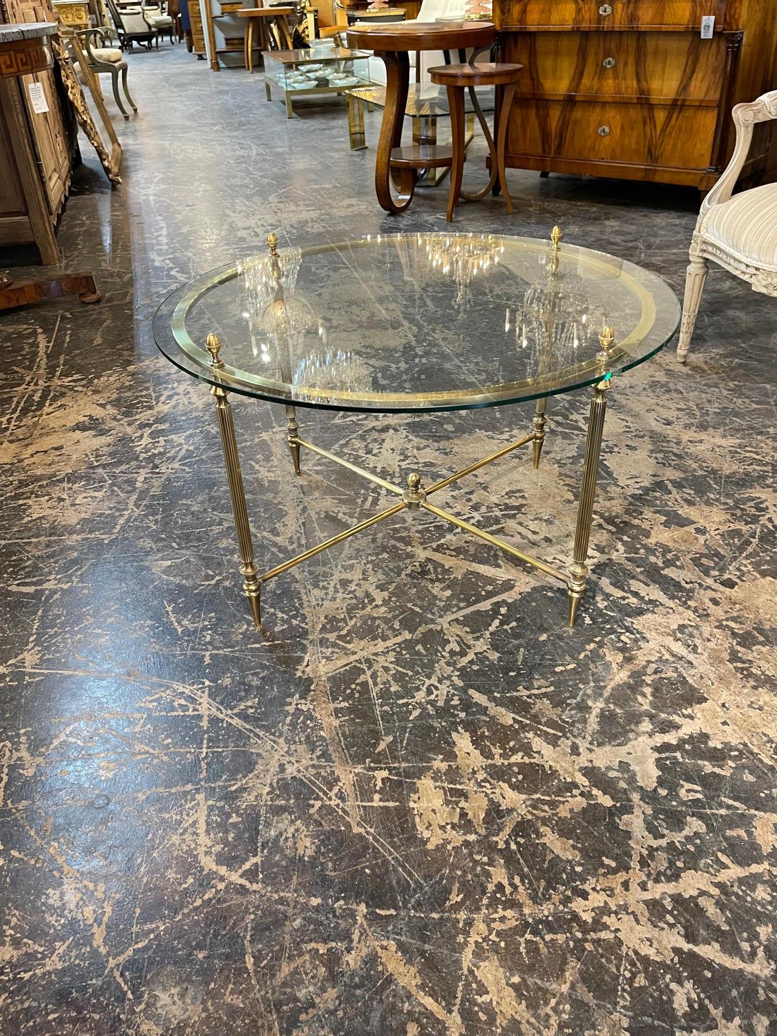 Vintage English polished brass round coffee table Circa 1940. It's a stunning little coffee table.