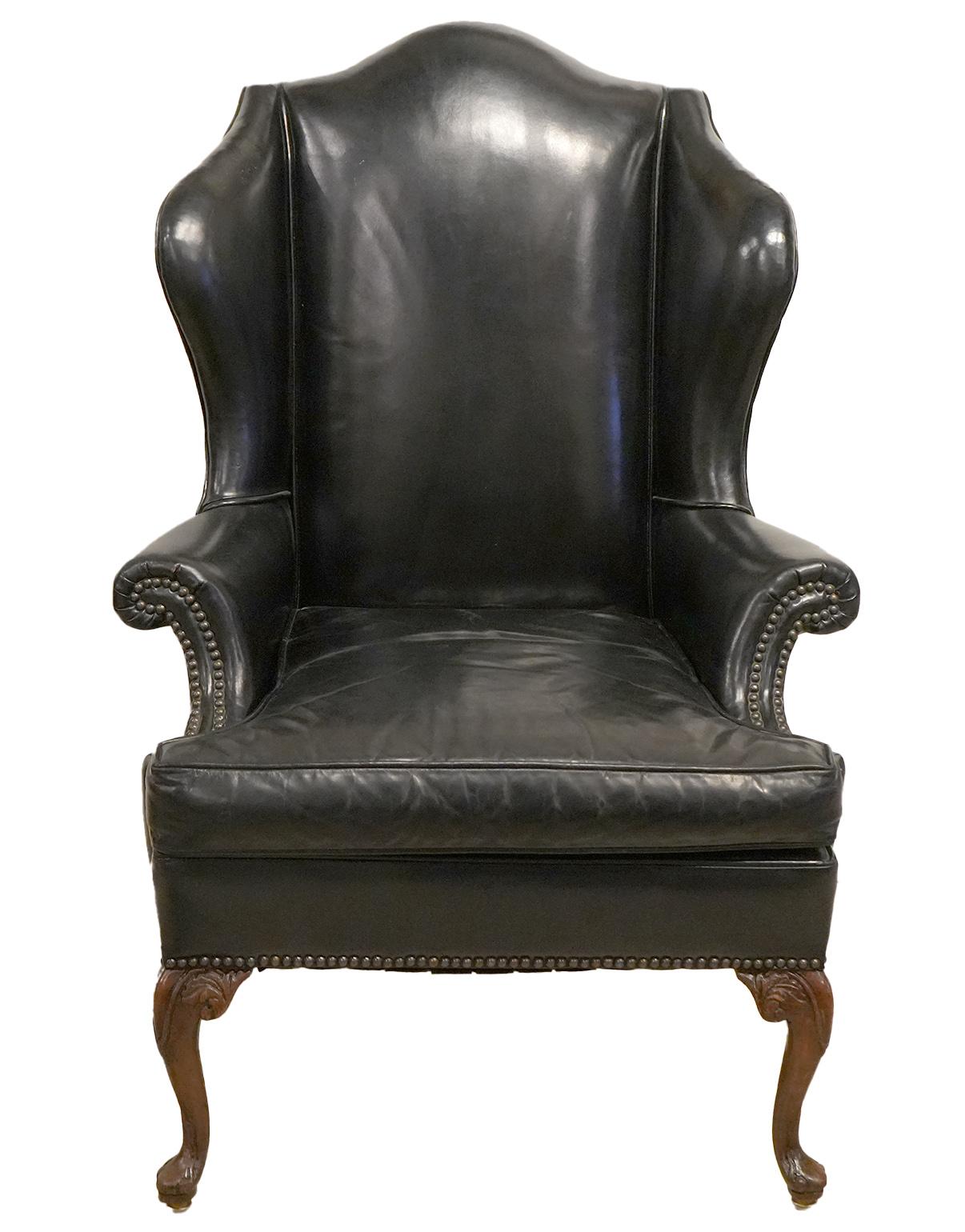Resting on carved cabriole shaped front legs and sabre style rear legs the sculptural quality of this Queen Anne style wing back chair looks inviting be it for reading a book, watching a game or taking a brake in the office. The camel back, the