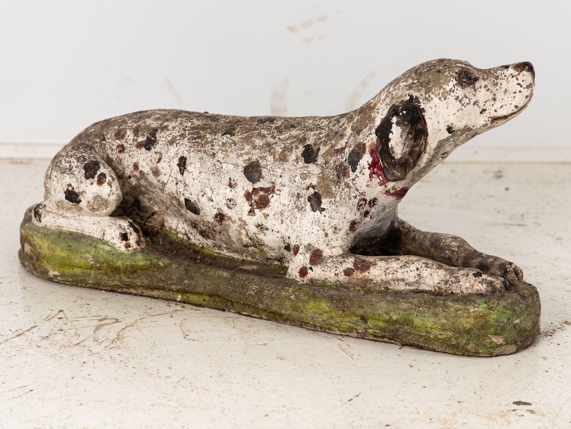 This exquisite garden ornament is a captivating portrayal of a recumbent Dalmatian, epitomizing grace and charm. Crafted with attention to detail, the sculpture captures the dalmatian's serene repose, its slender body elegantly stretched out. The
