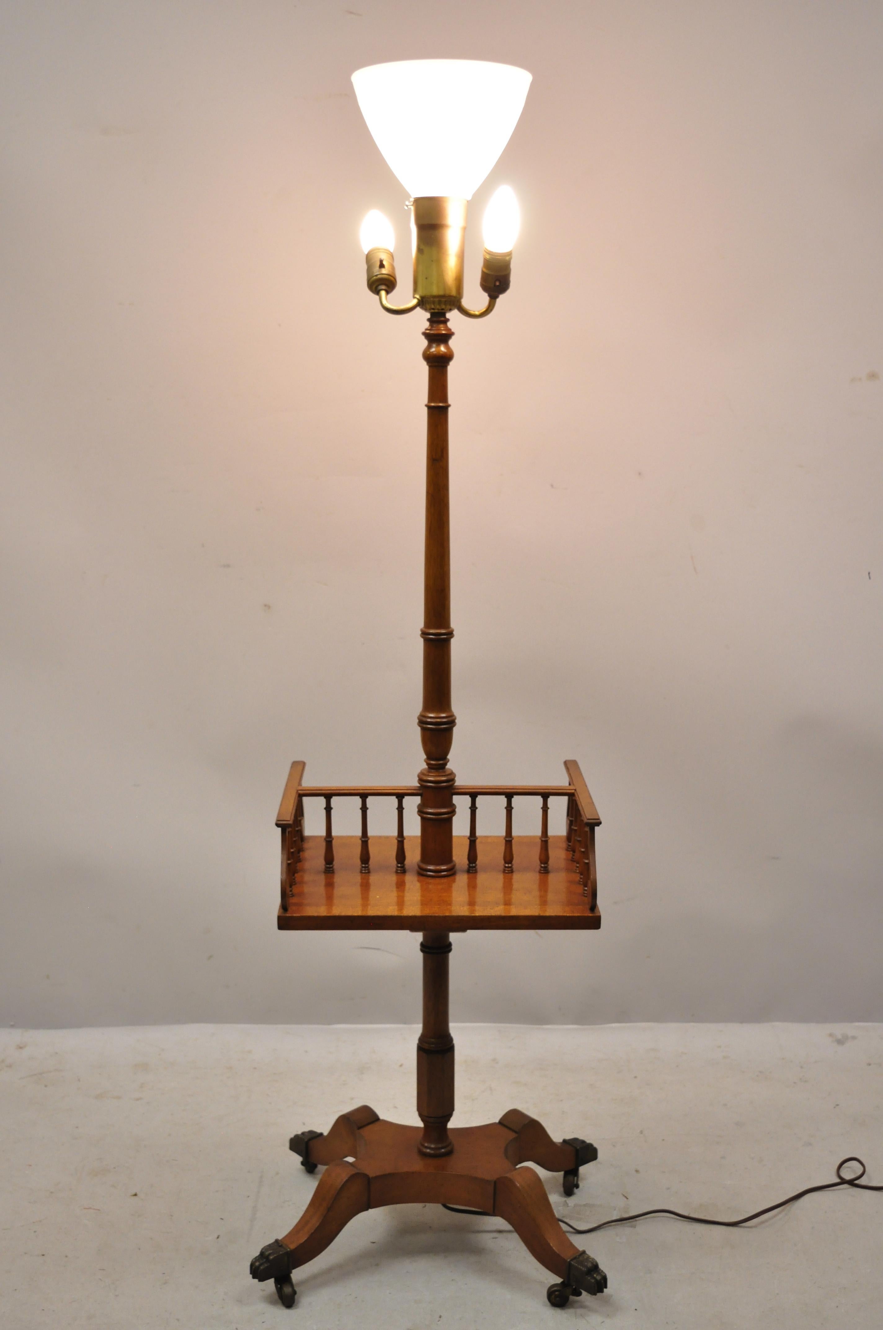 Vintage English Regency style mahogany floor table lamp with carved harp gallery. Item features brass paw feet and rolling casters, carved 