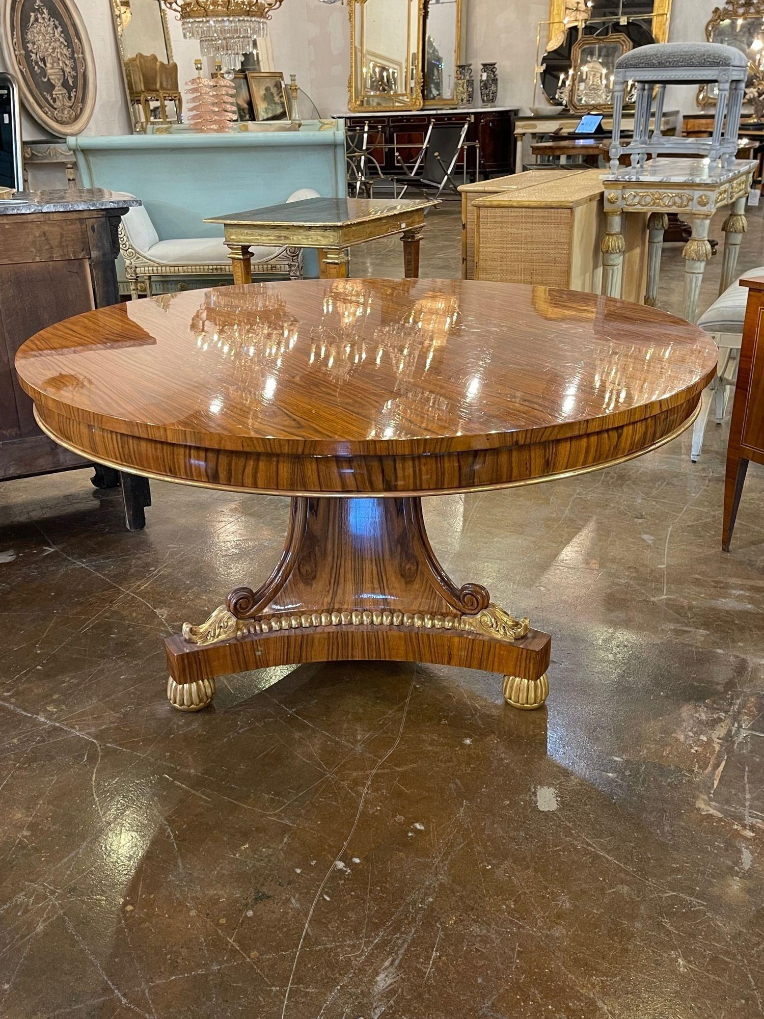 Elegant vintage English Regency style Rosewood and gilt center table. Featuring beautiful wood grain and an extremely polished finish along with the gilt details. Creates a very sophisticated look! Fabulous!