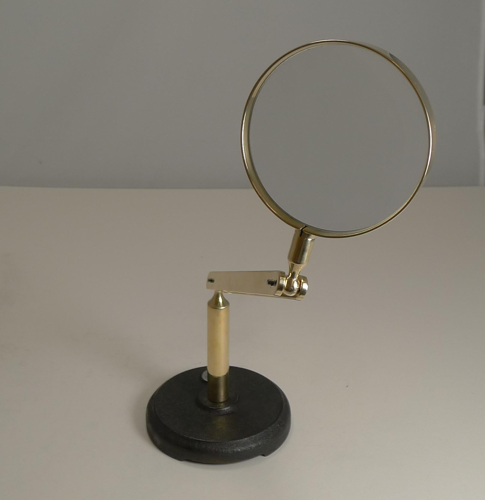 An unusual vintage magnifying glass standing on a hefty iron foot mounted with the makers signature for C. Baker, London, traded at 244 High Holborn, London (1910-1947).

The brass reticulated arm is also marked W.S.M. PIRE and a Patent