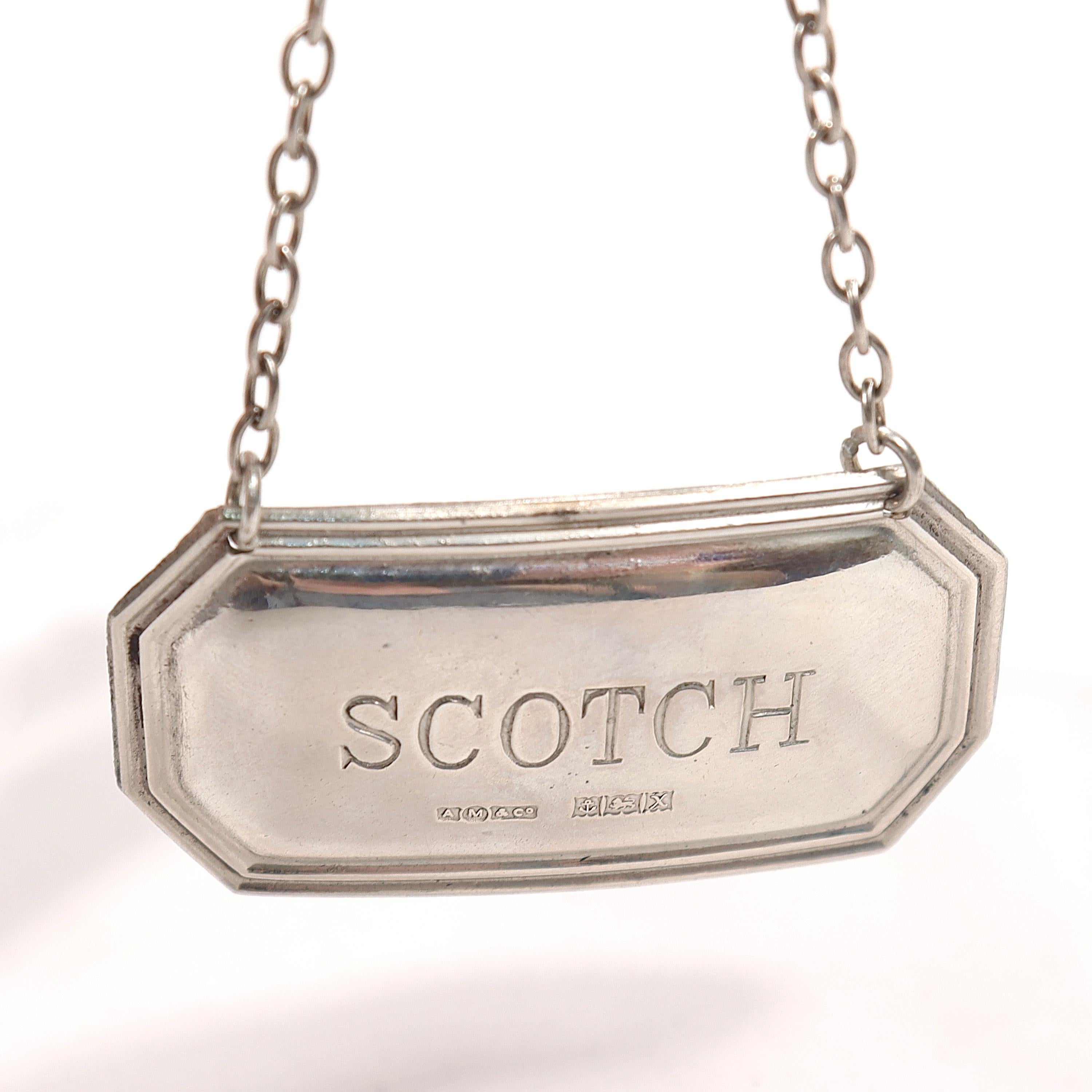 A fine vintage English scotch decanter or liquor label.

In sterling silver.

By A Marston & Co. 

The octagonal silver label hangs on a chain and reads: SCOTCH

Marked with English hallmarks for A. Marston & Co., Birmingham, Sterling, 1972.
